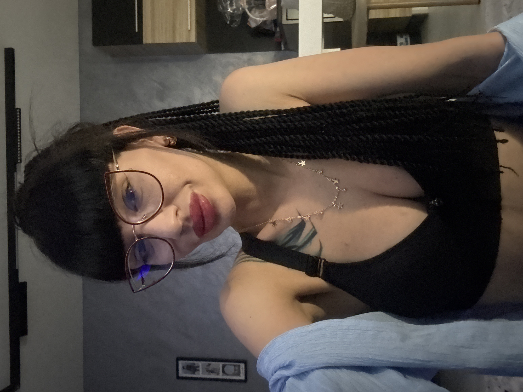 Indoor portrait with cat-eye glasses in Varna, Bulgaria.