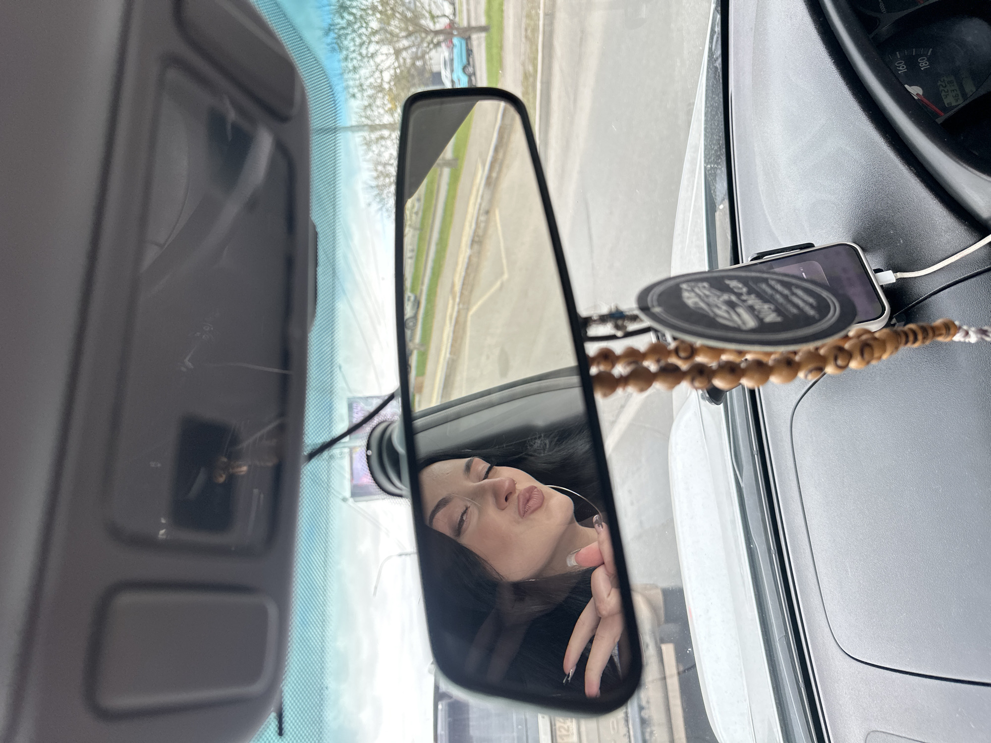 Two women singing in car during Krasnoyarsk traffic stop