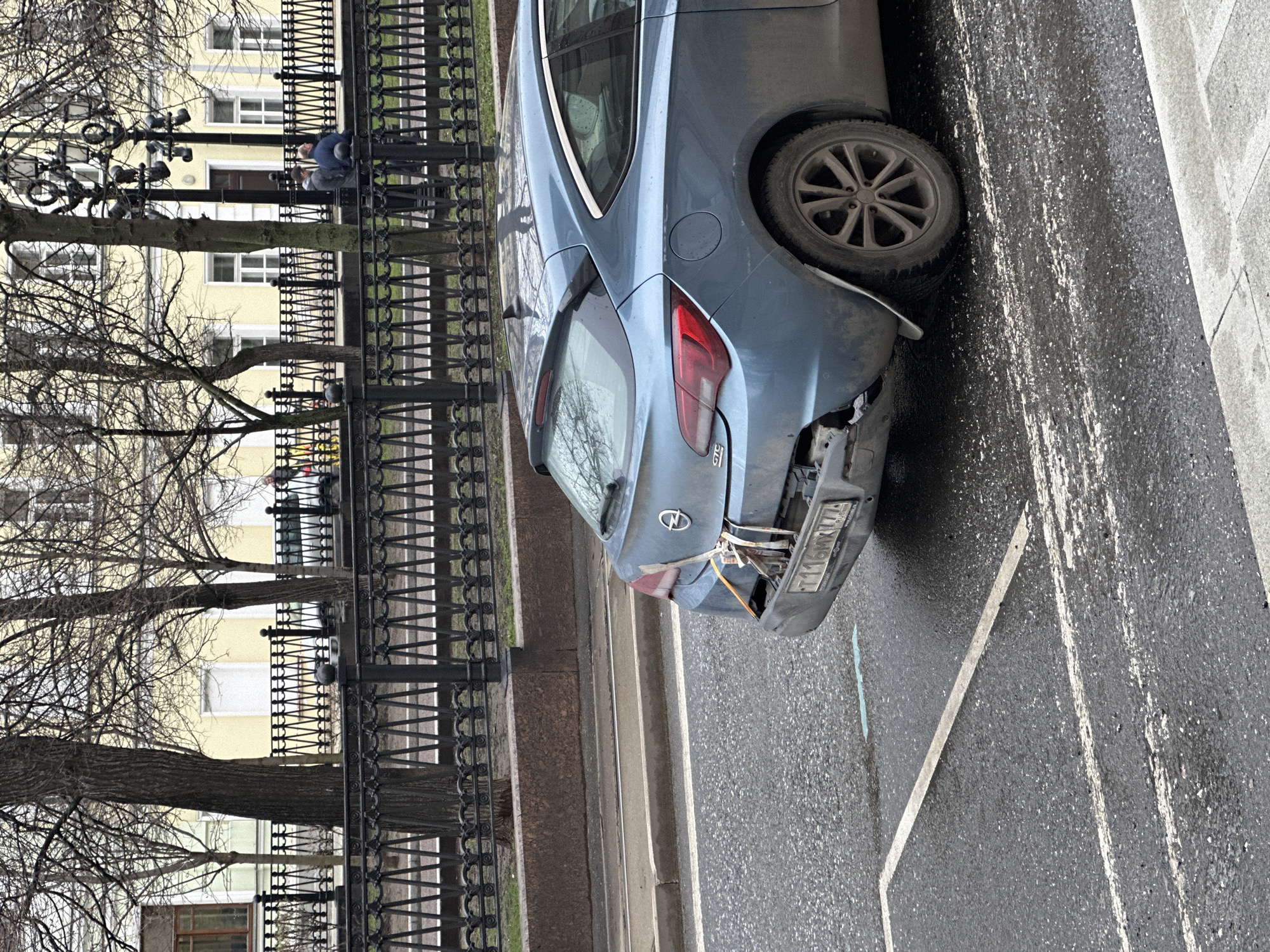 Damaged Opel Astra observed on Moscow street amid wet conditions