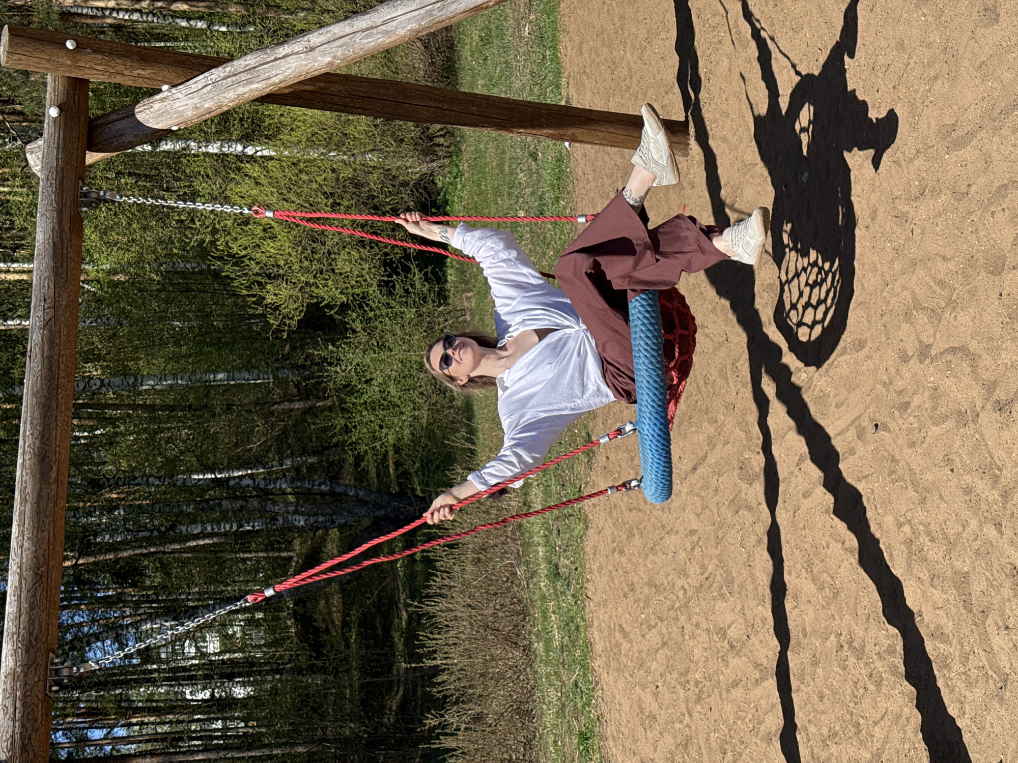 Woman enjoys tire swing at Chaikovsky recreation area