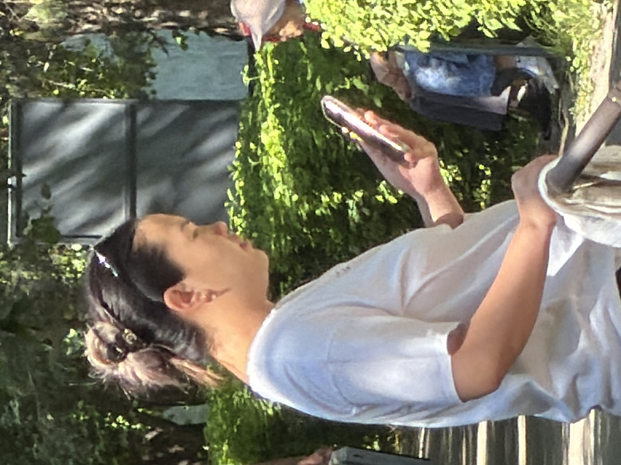 Morning park activity with walking, sitting, and phone use