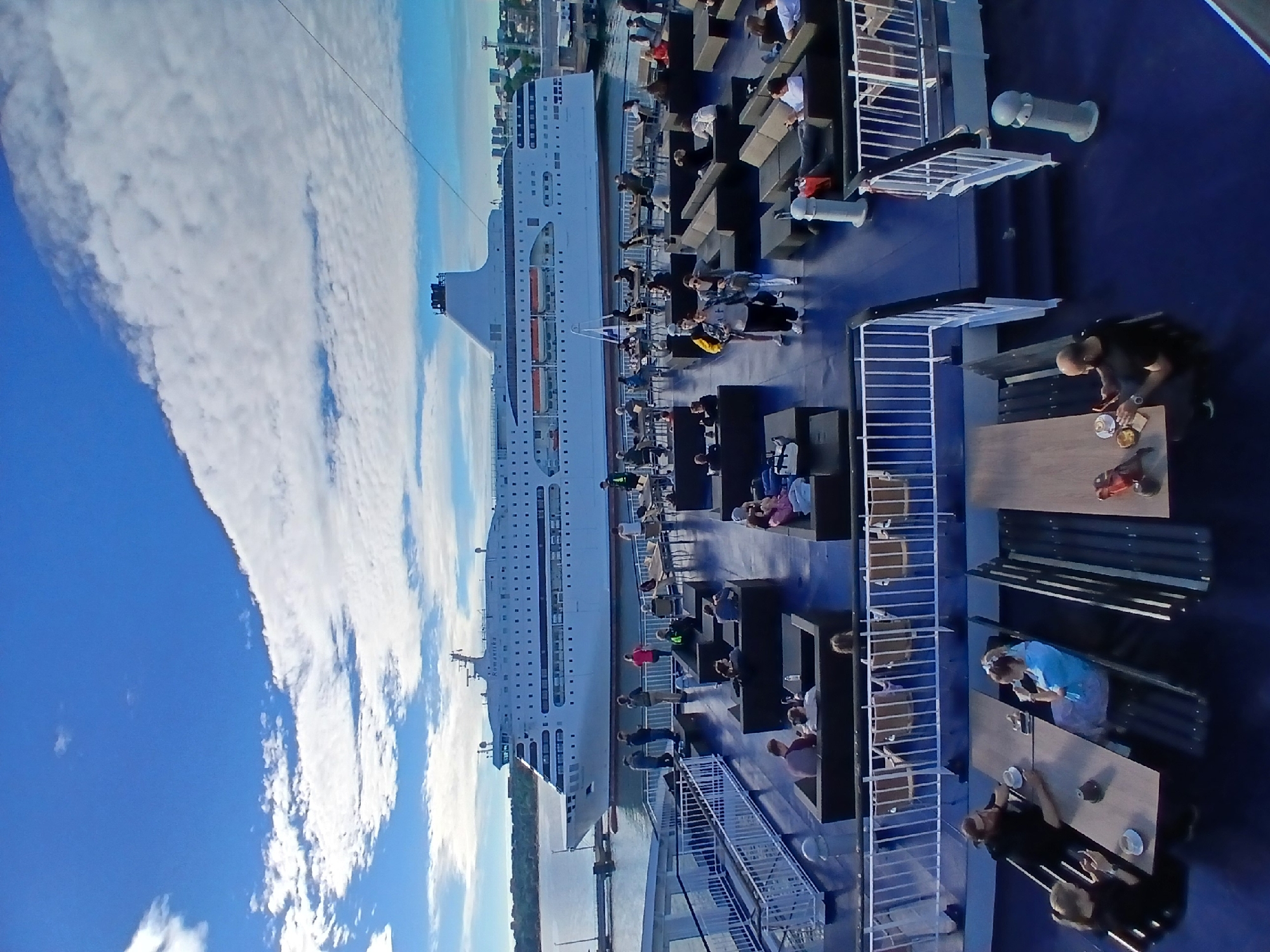 Ferry deck life in Tallinn harbor on a calm summer morning