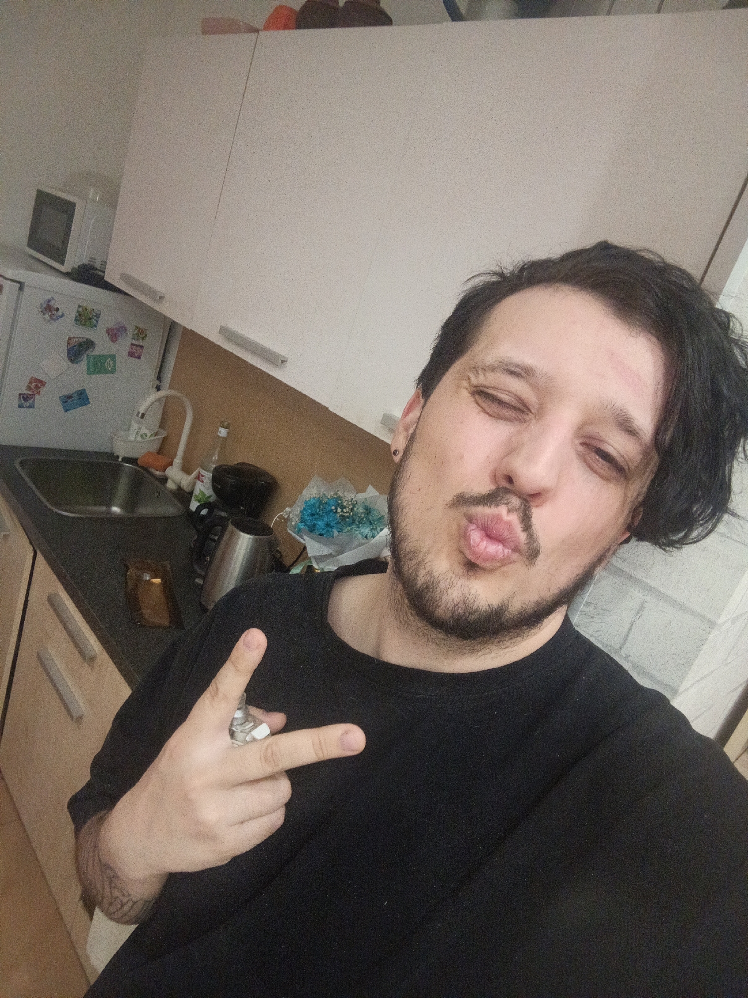 Man takes selfies, uses laptop in Penza kitchen