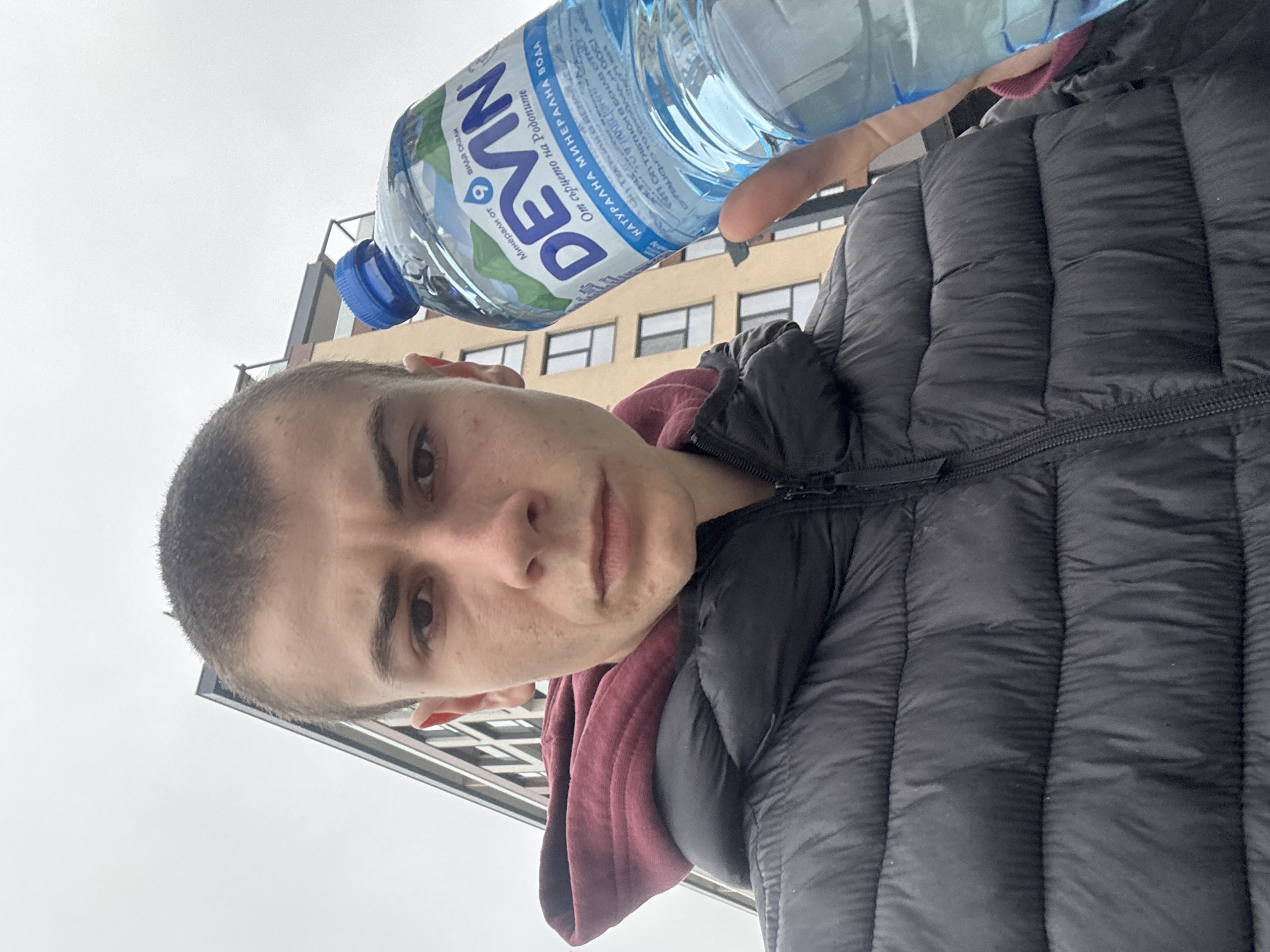 Person with water bottle documented around Plovdiv building