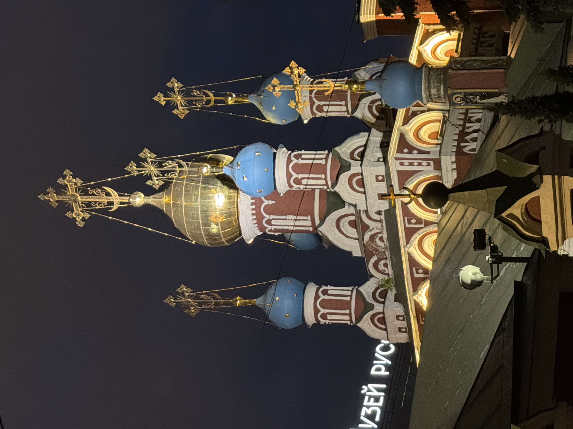 Moscow's historic churches illuminate evening cityscape amid regular traffic