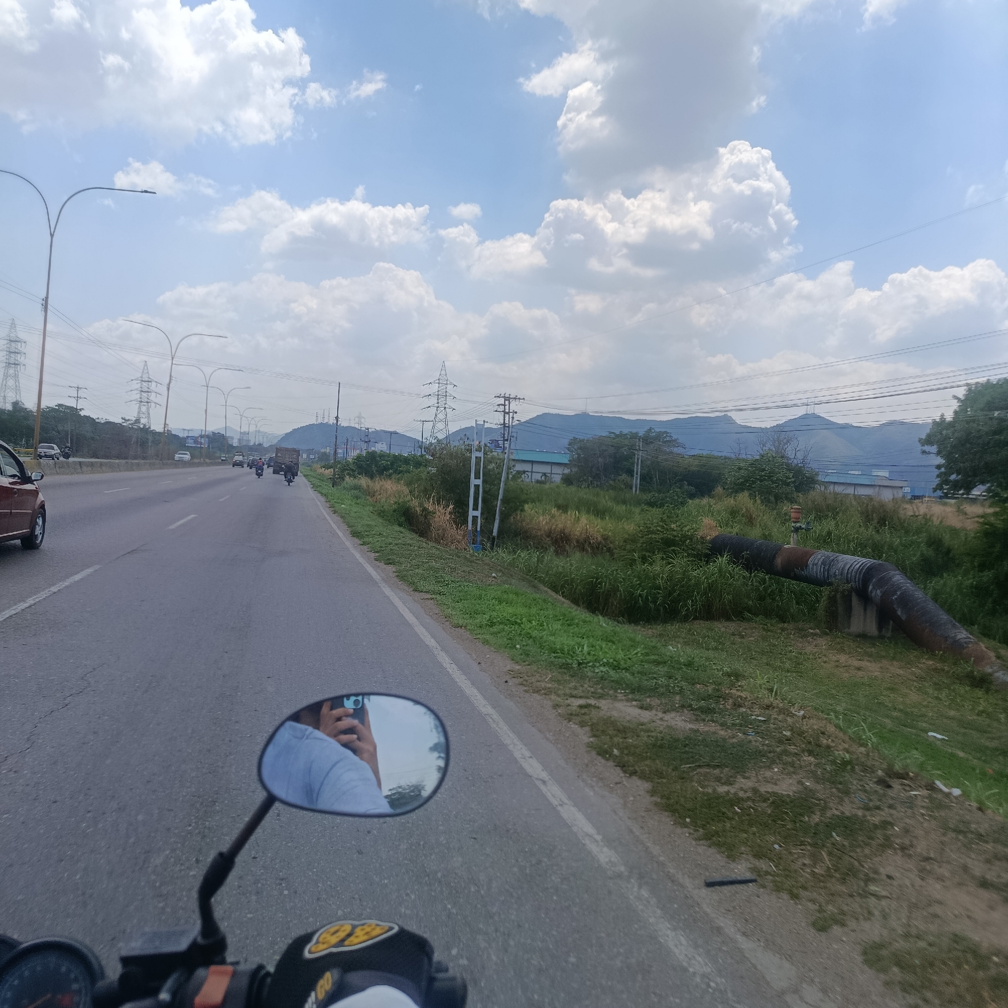 Motorcycle rider travels highway in Los Guayos, Venezuela