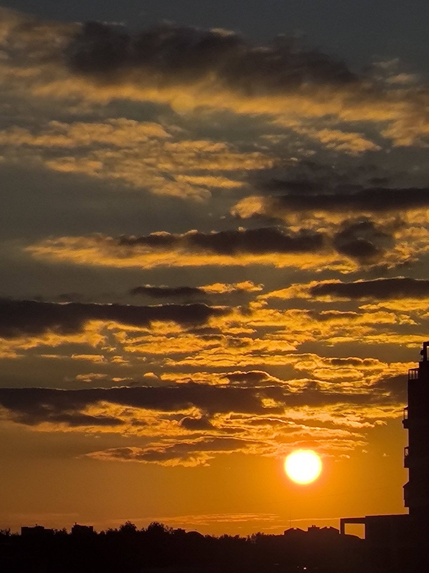 Golden sunset breaks through cloud cover over Khimki