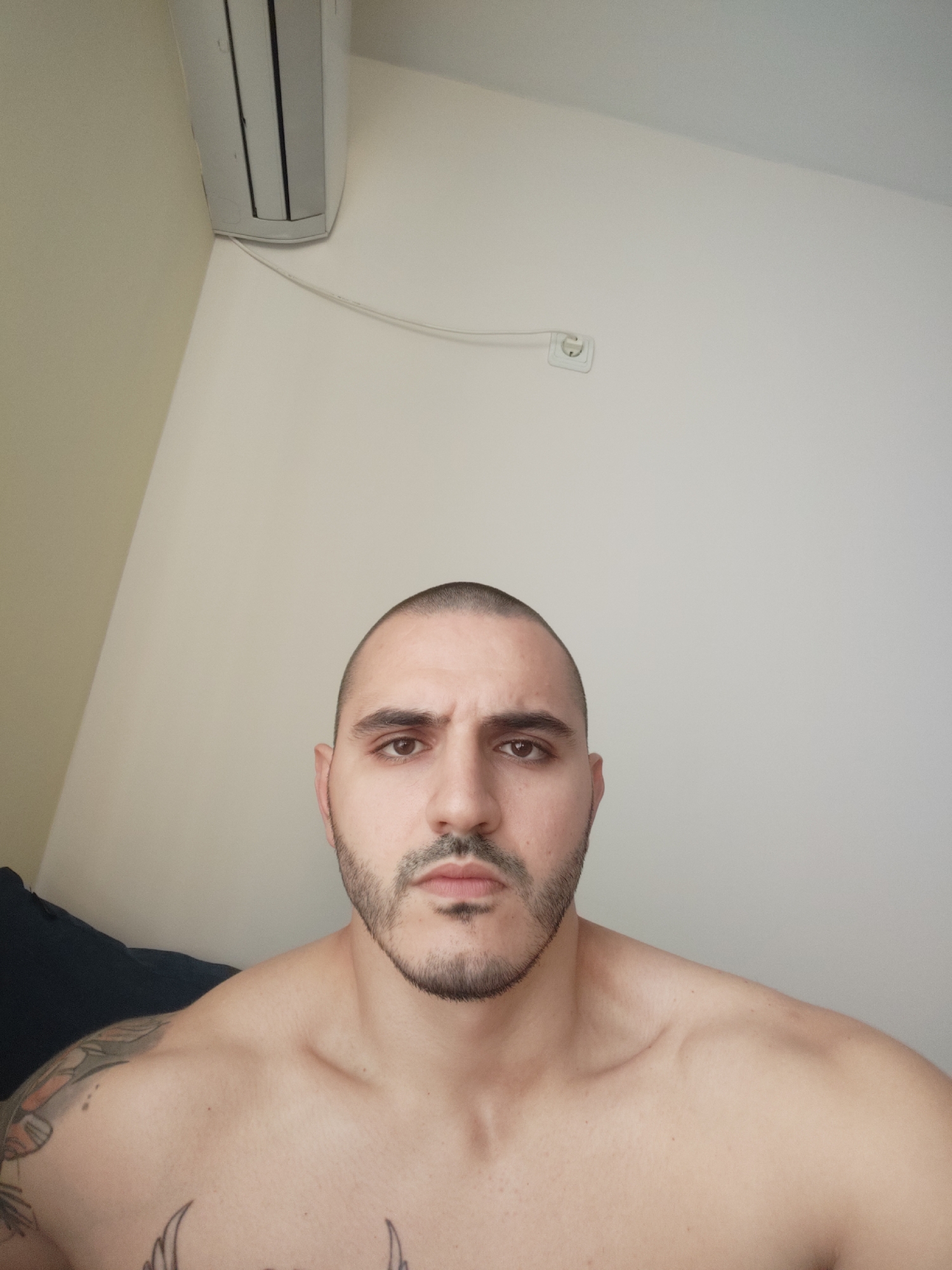 Tattooed man observed indoors during afternoon hours