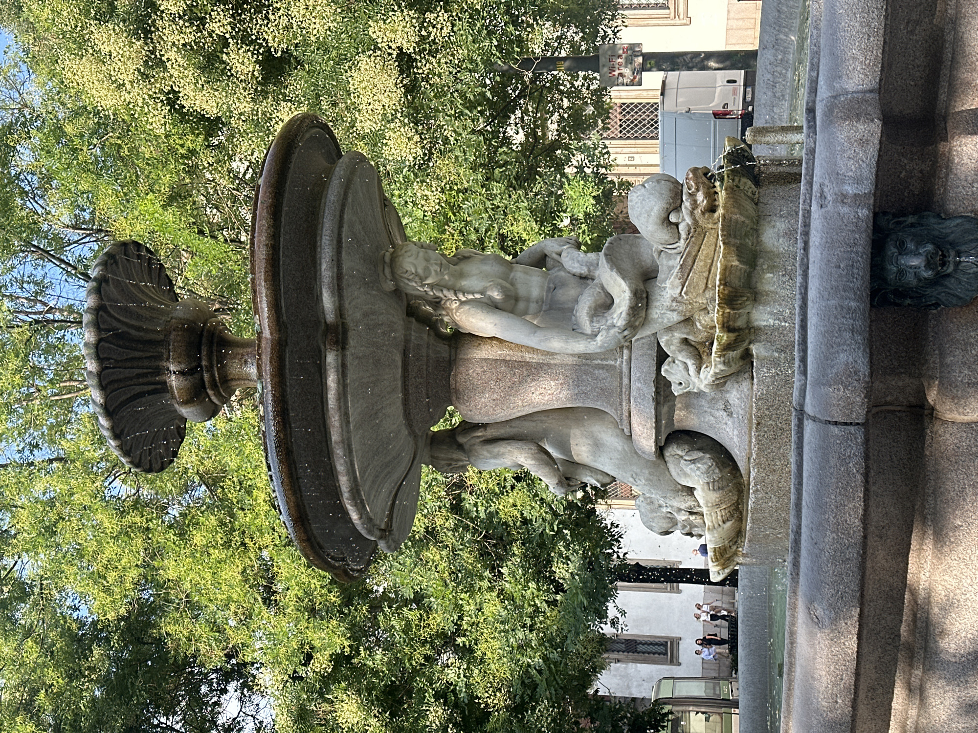 Ornate stone fountain with marine sculptures in Milan