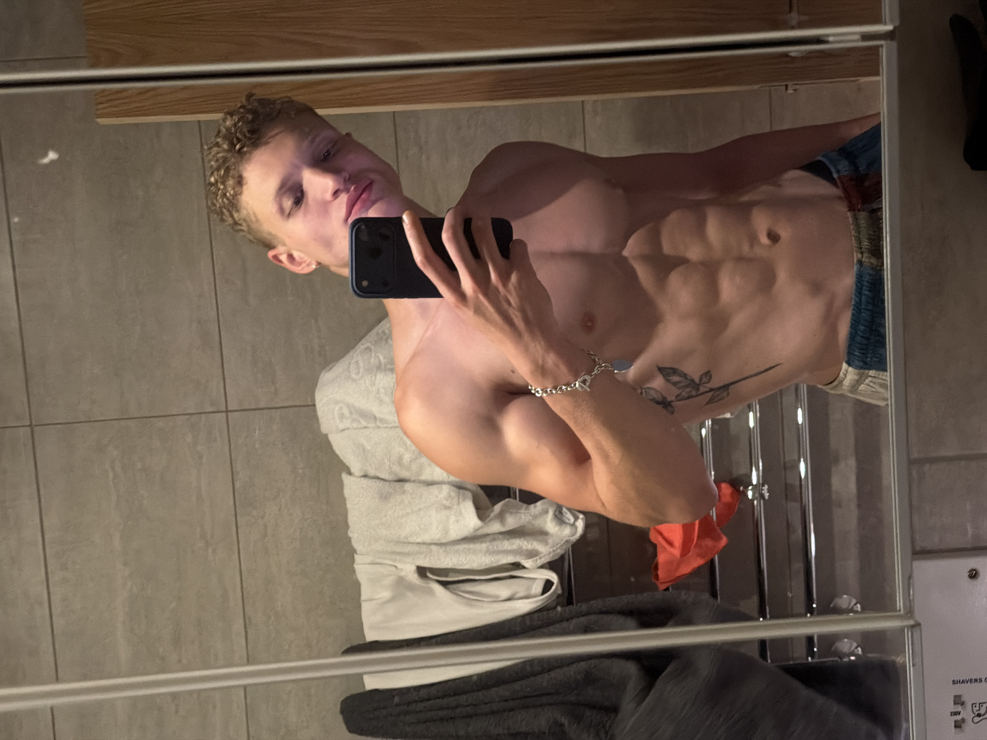 Young man takes bathroom mirror selfies in London
