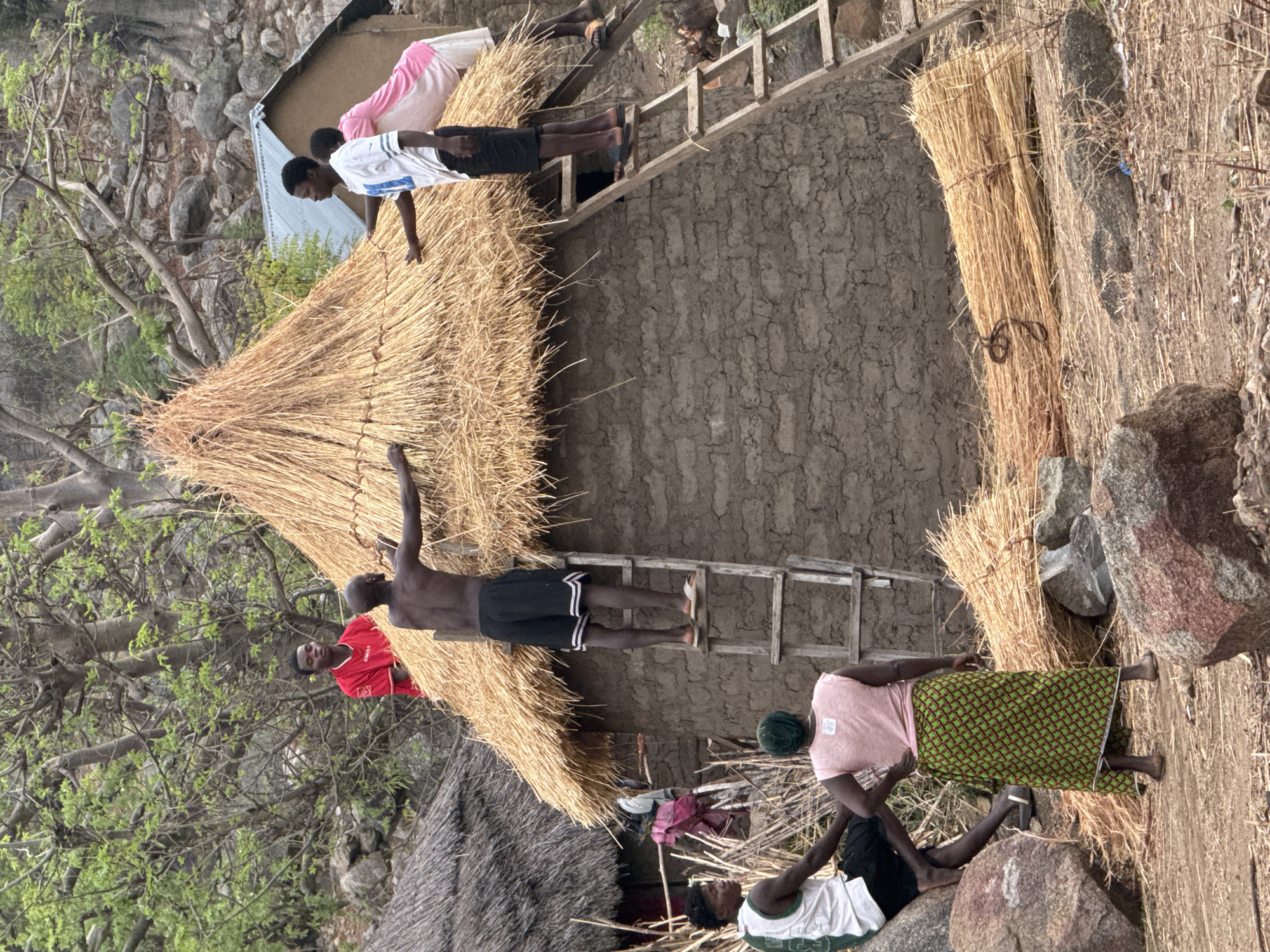Community construction work on traditional house in Dawaki, Nigeria