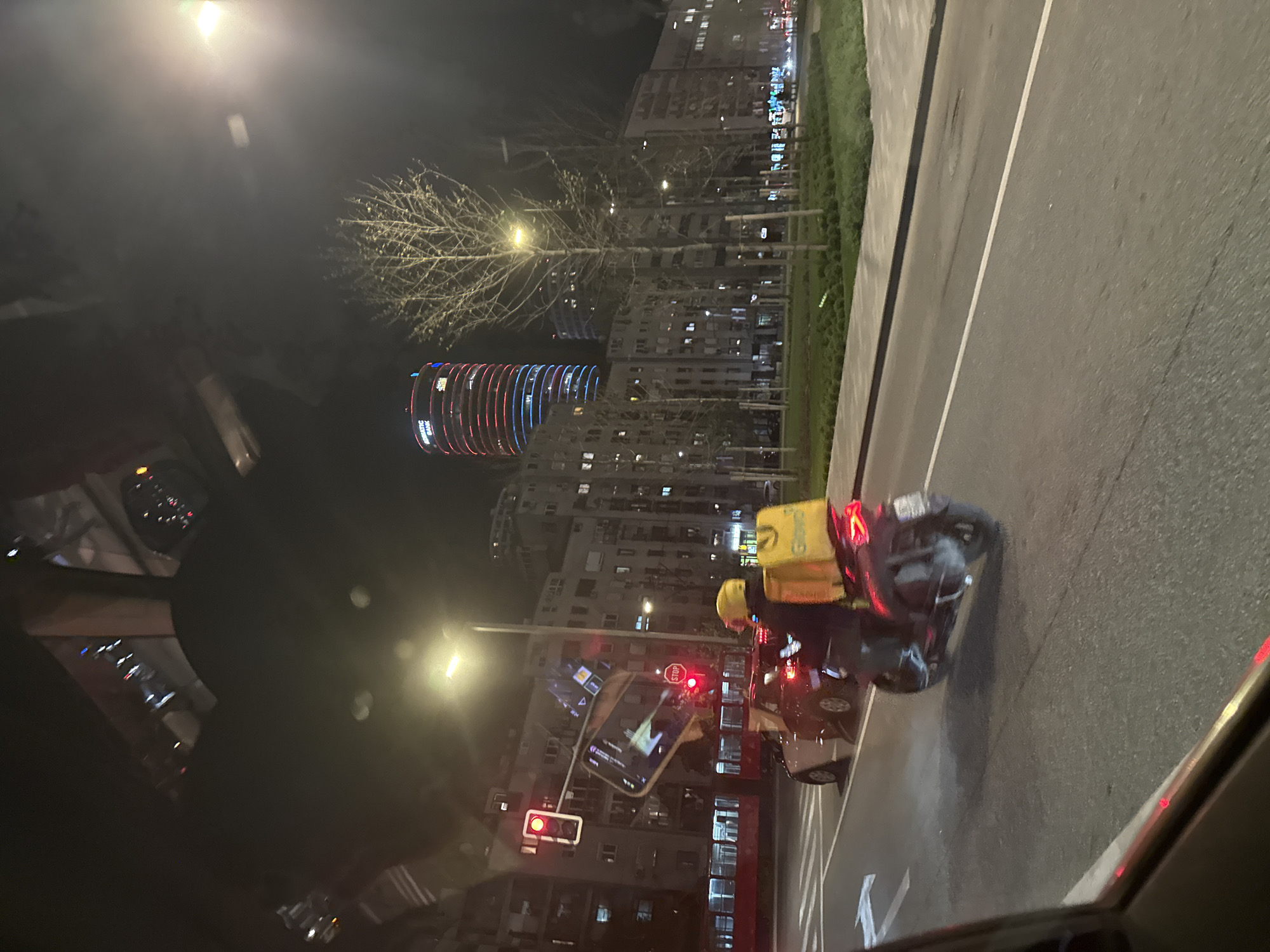 Delivery scooter stops at red light in Belgrade