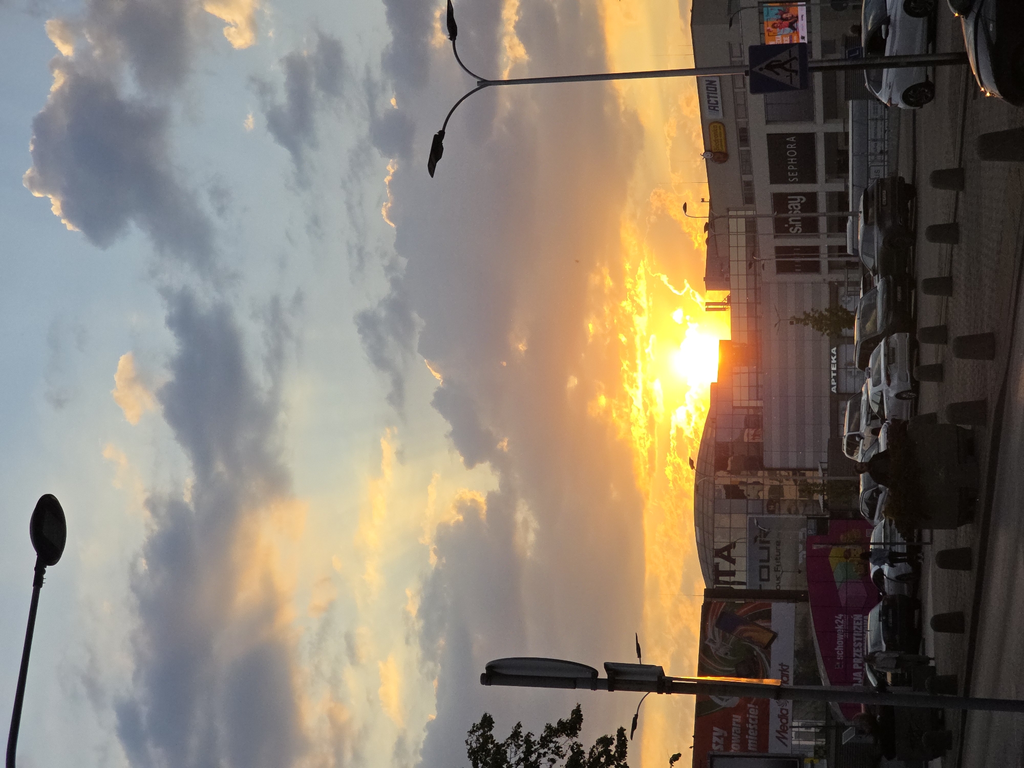 Dramatic sunset illuminates Warsaw commercial district glass facades