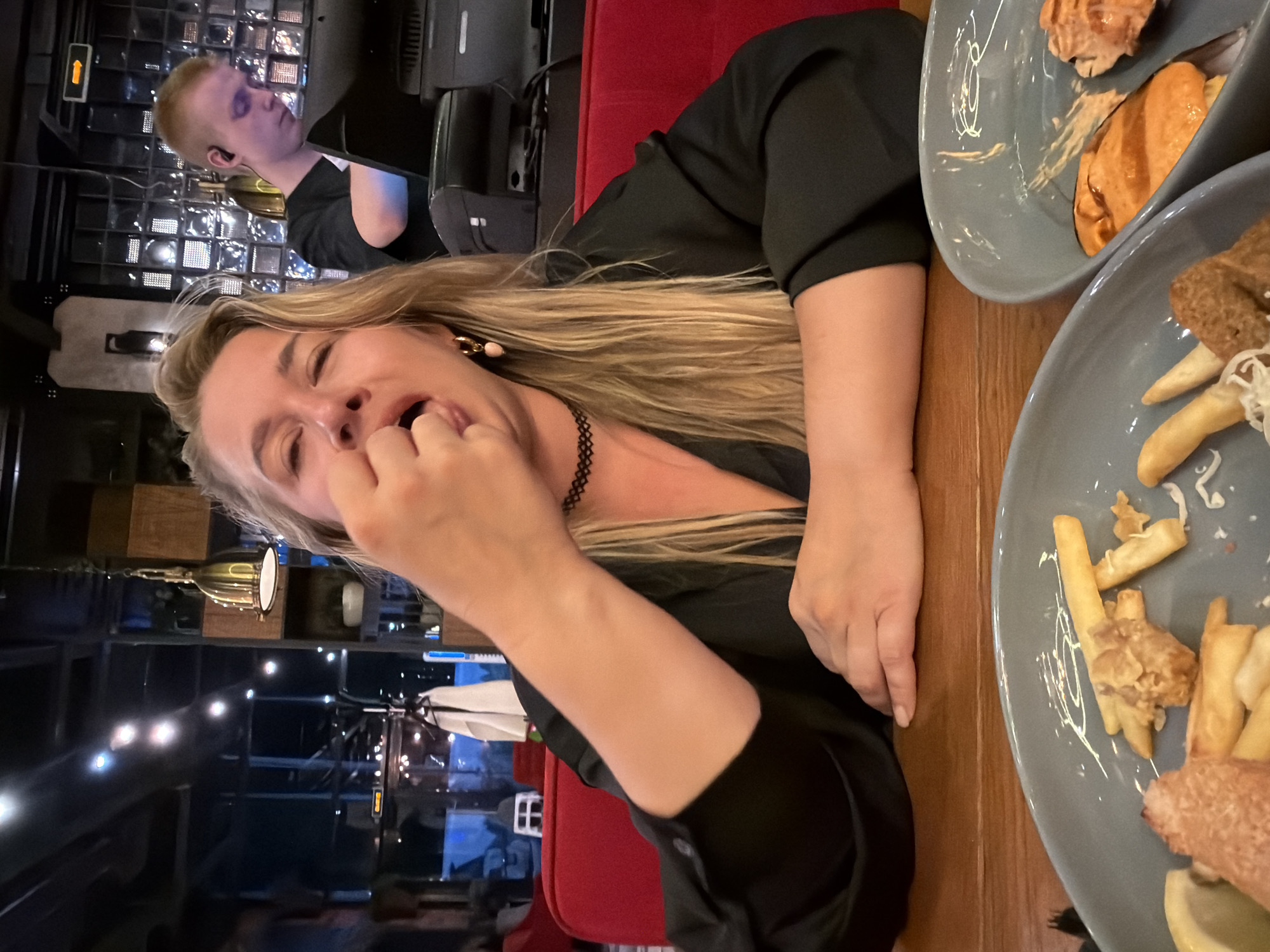 Casual dinner at a Russian restaurant, phones and fries on the table.