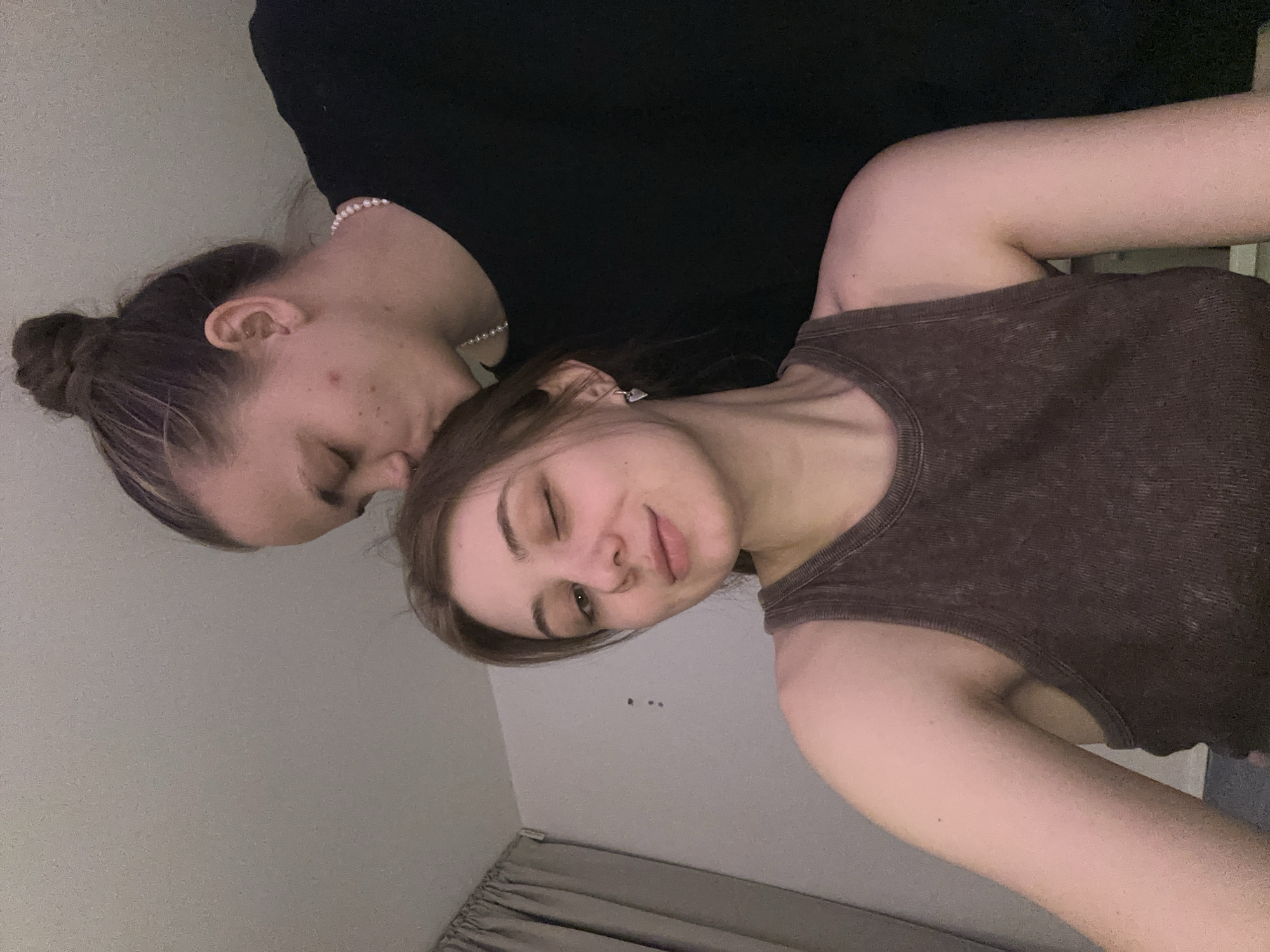 Two women pose intimately indoors in Moscow