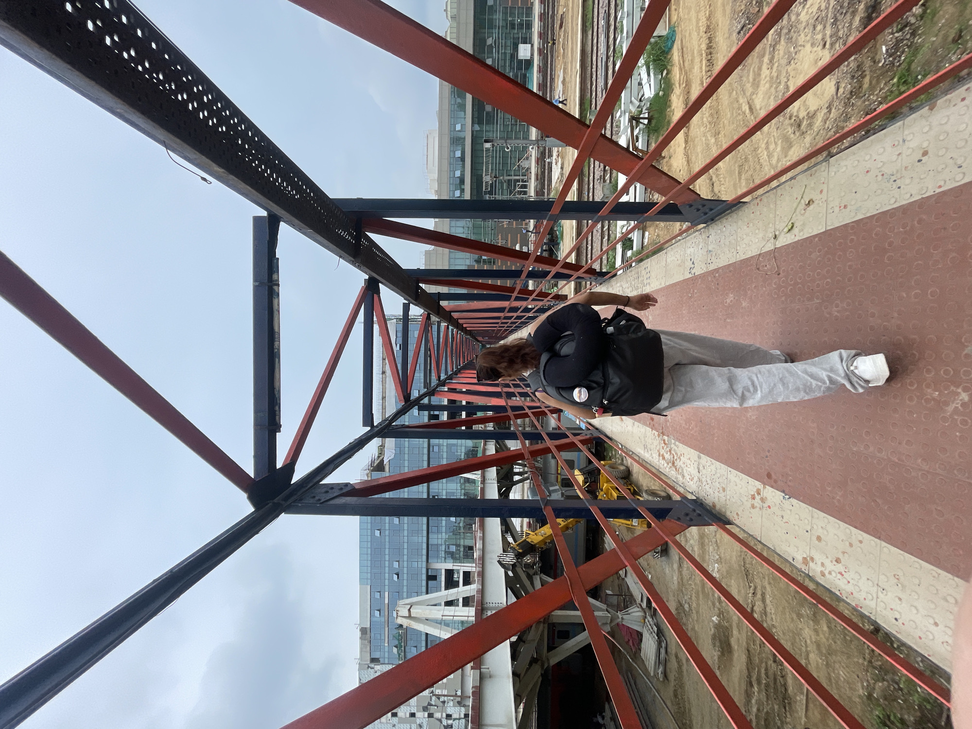 Construction and commuter activity around a New Delhi rail corridor