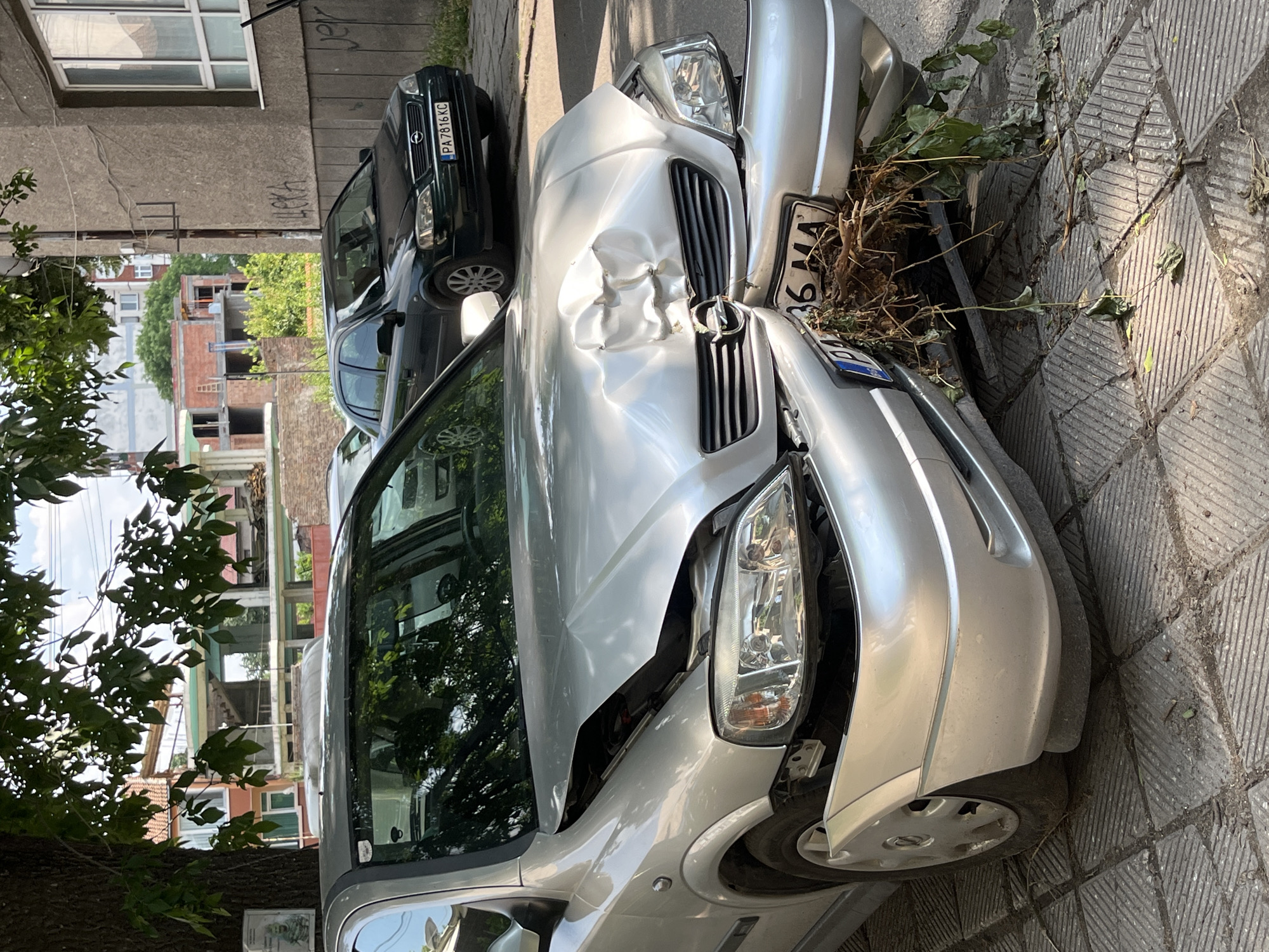 Damaged vehicle documented on Pazardzhik street amid residential buildings