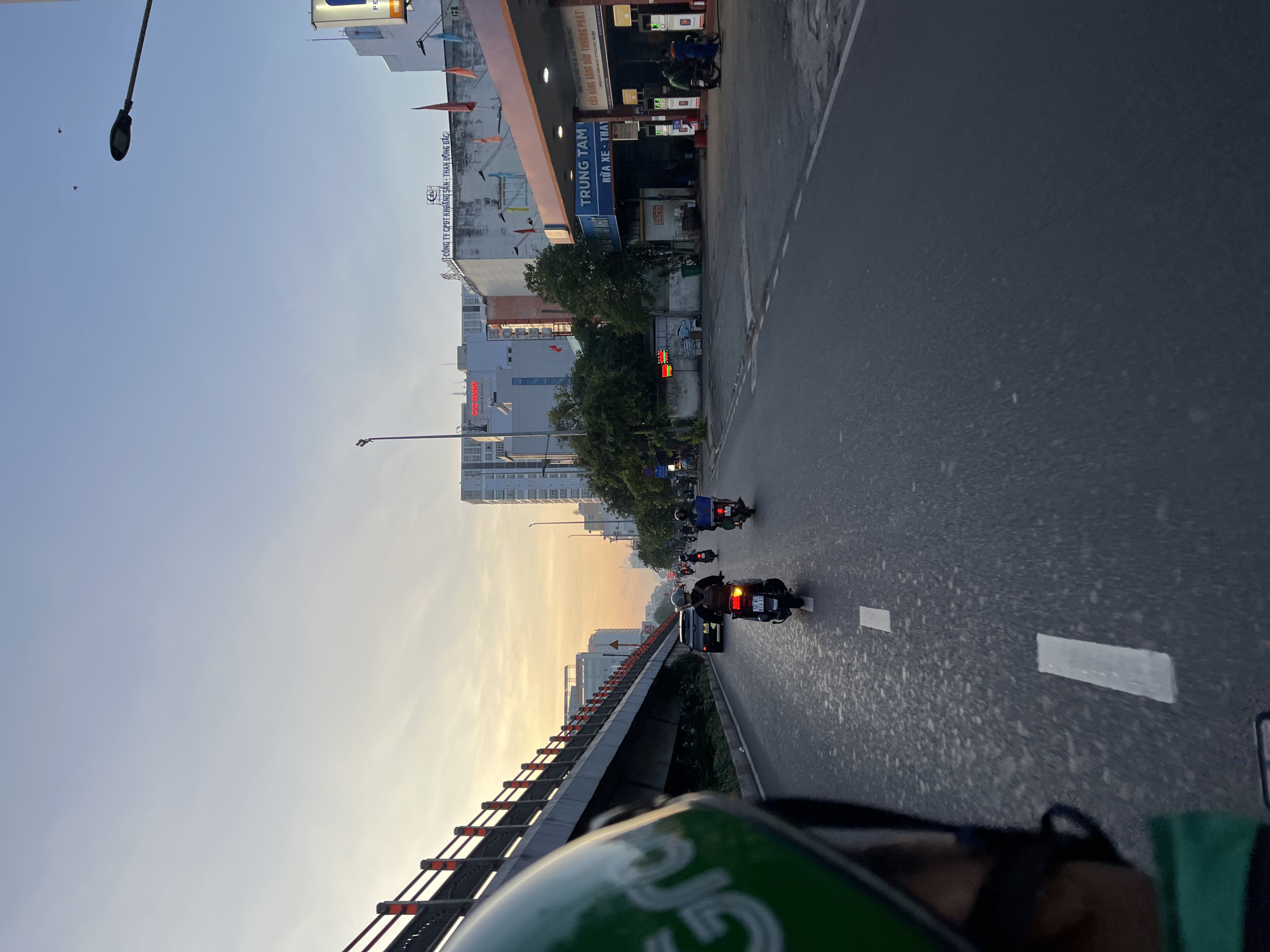 Grab delivery rider travels multi-lane road in Thuận An