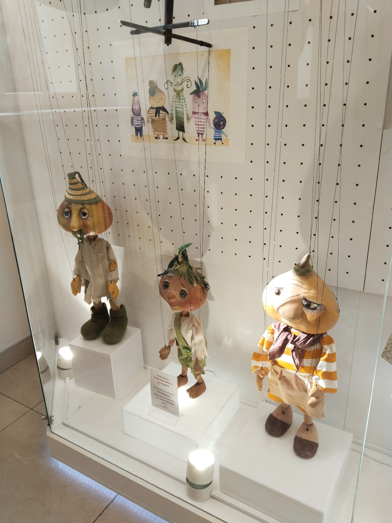 Vegetable puppets displayed in glass case in Murmansk