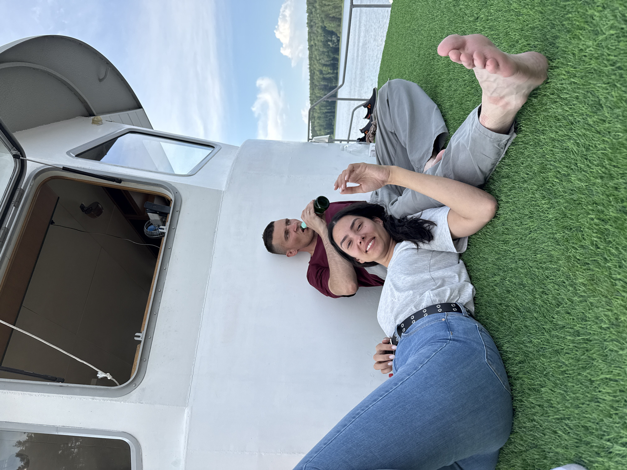 Friends enjoy leisurely boat trip and water activities in Chaykovsky