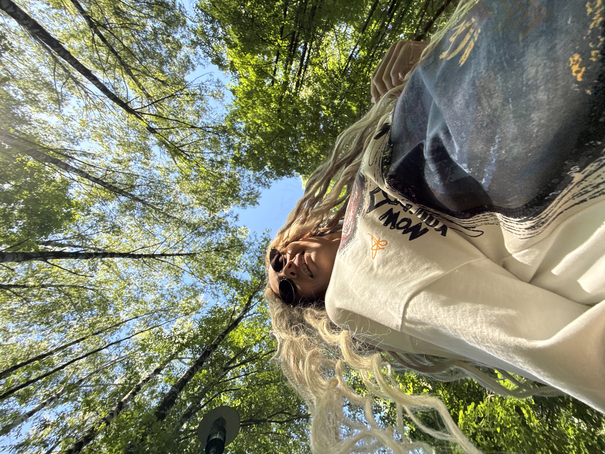 Woman takes forest selfies in Rusanovo during morning photo session