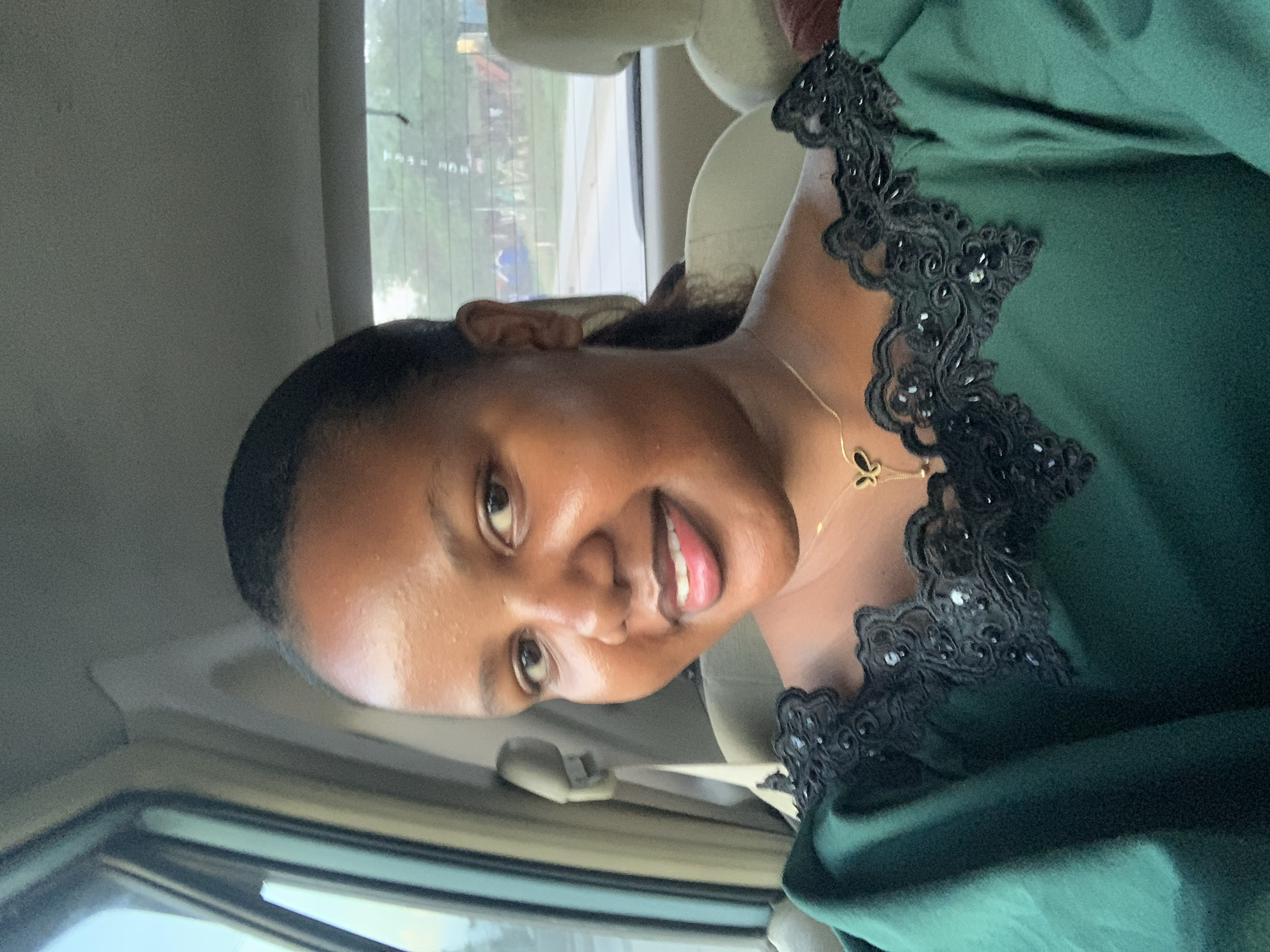 Woman in green lace top observed in vehicle in Dar es Salaam