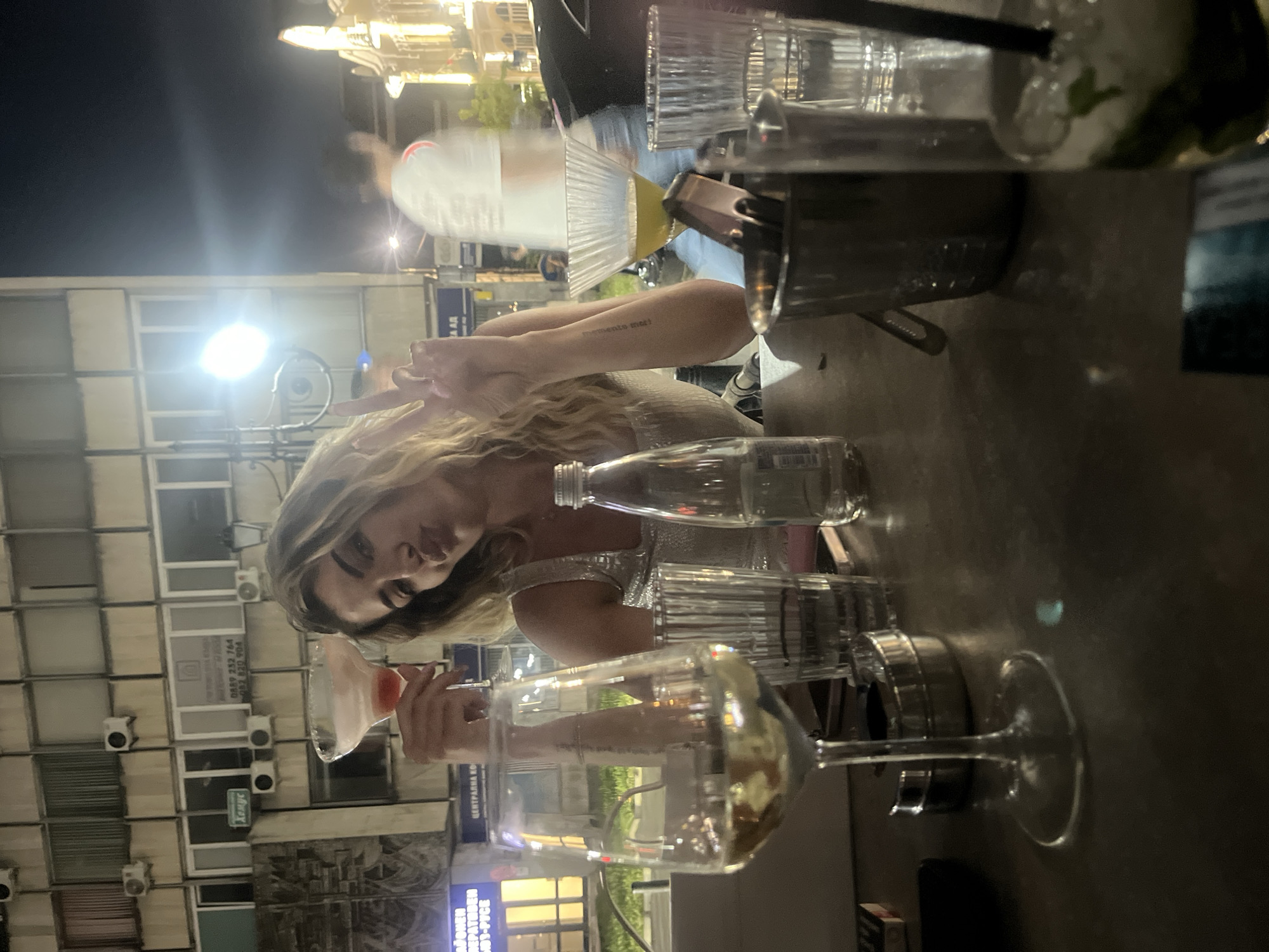 Evening drinks at an outdoor urban spot with cocktails and street art nearby