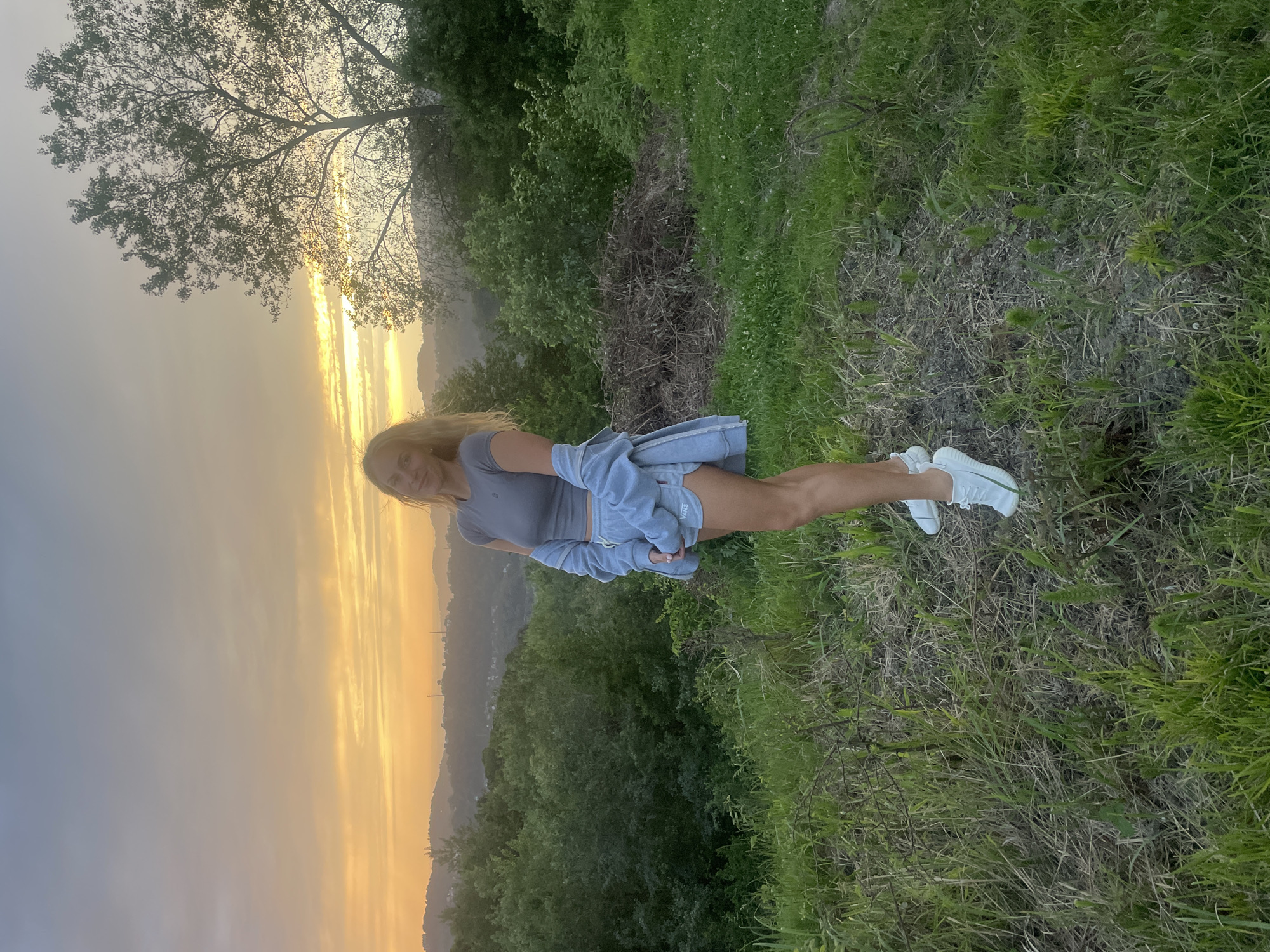 Woman enjoys sunset view in Russian countryside near Baranovka