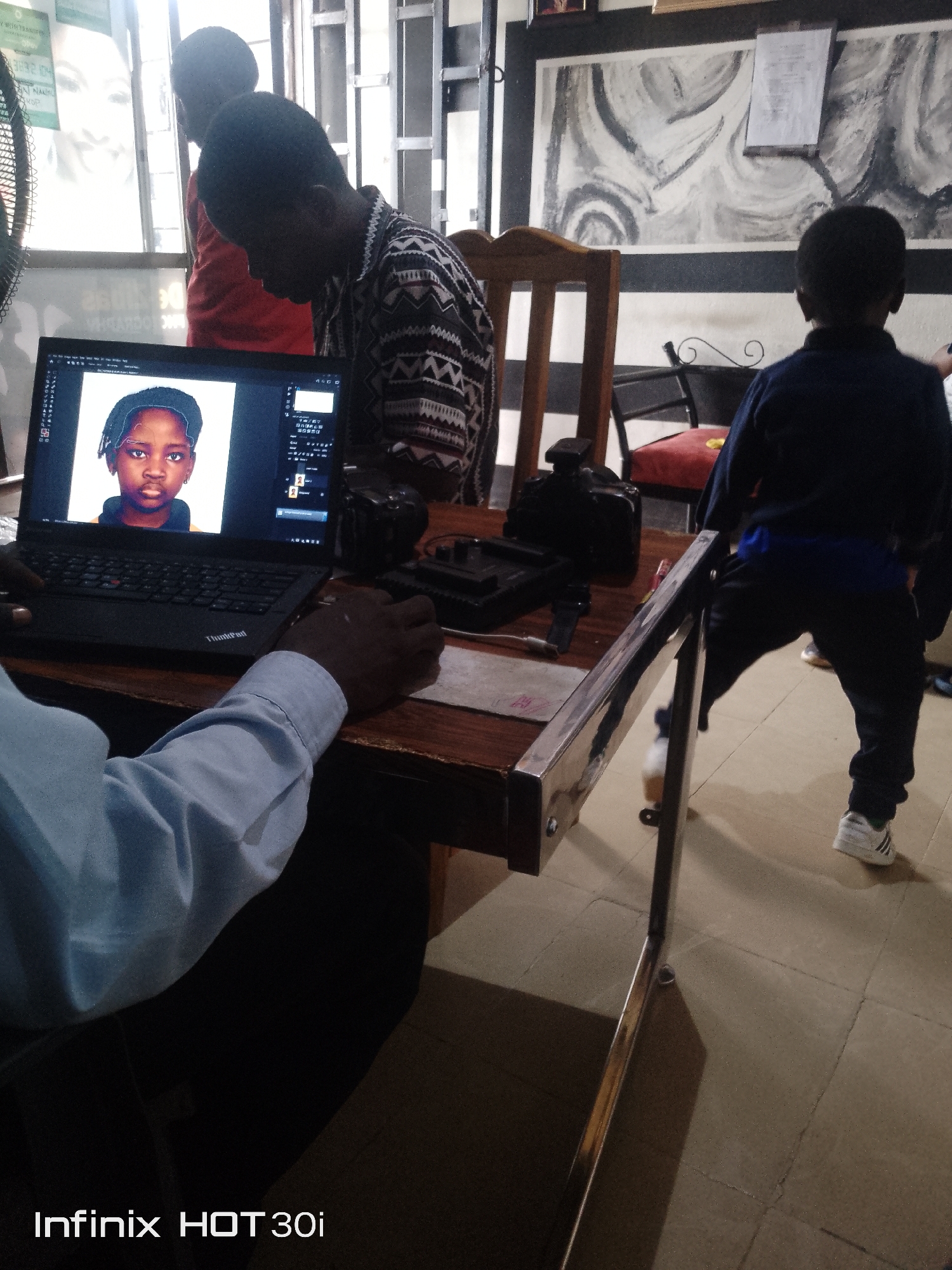 Laid-back afternoon indoors, kids around, laptops open
