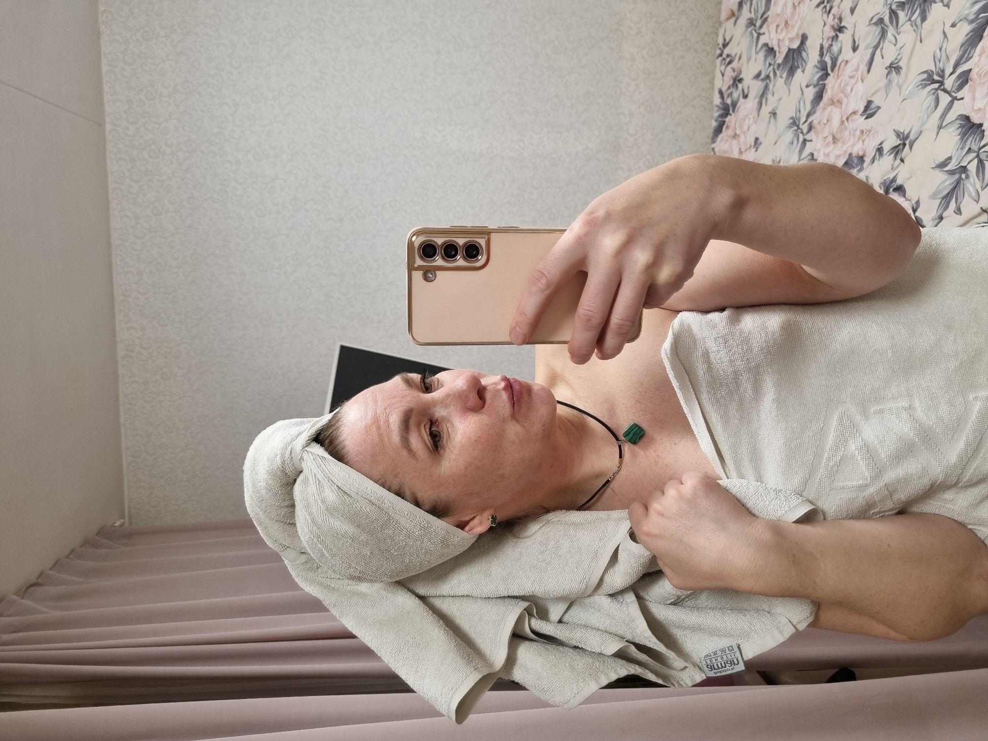 Woman takes post-bath selfies in bedroom in Chaikovsky