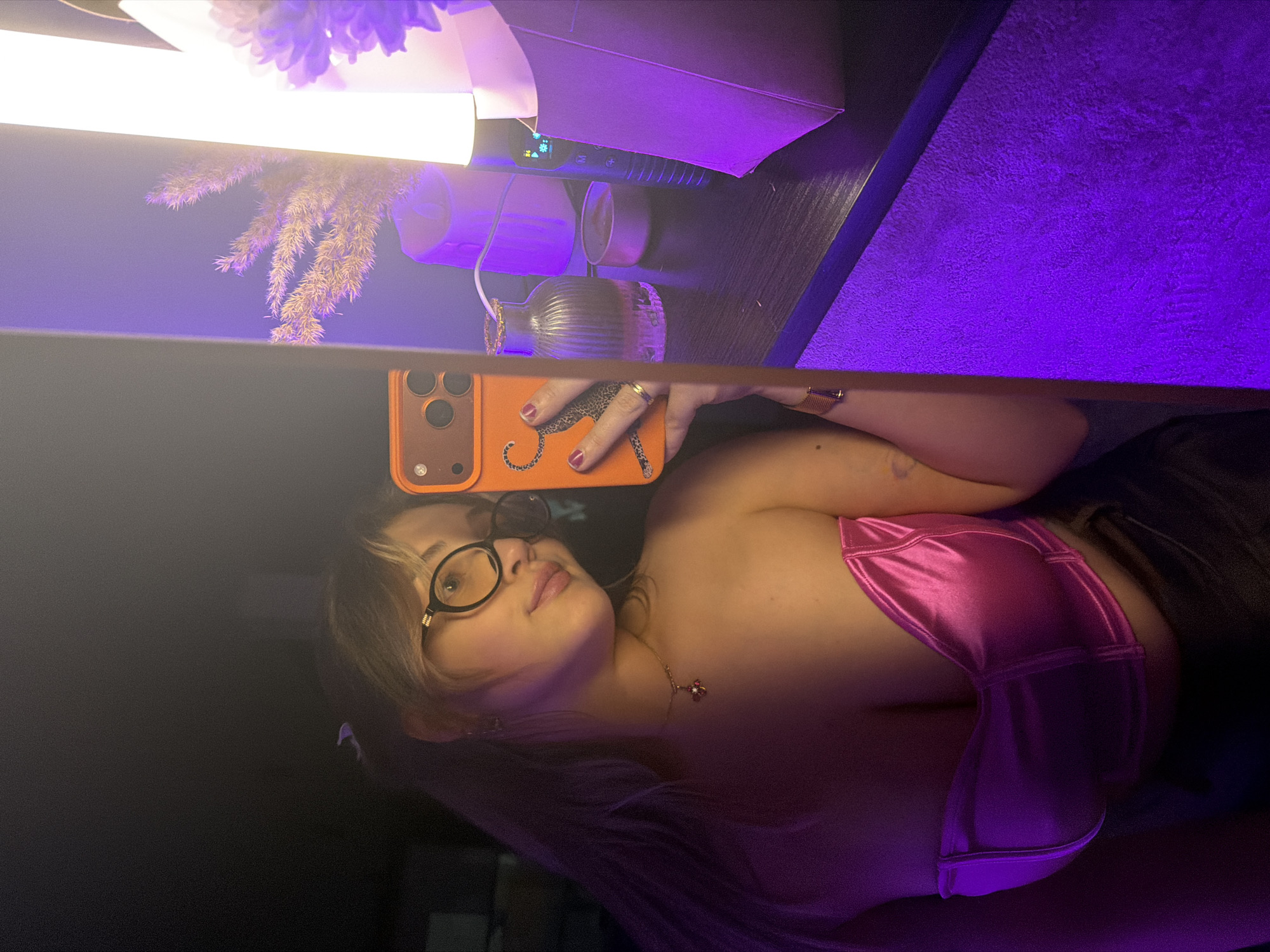 Woman takes selfies with orange phone in Russian village