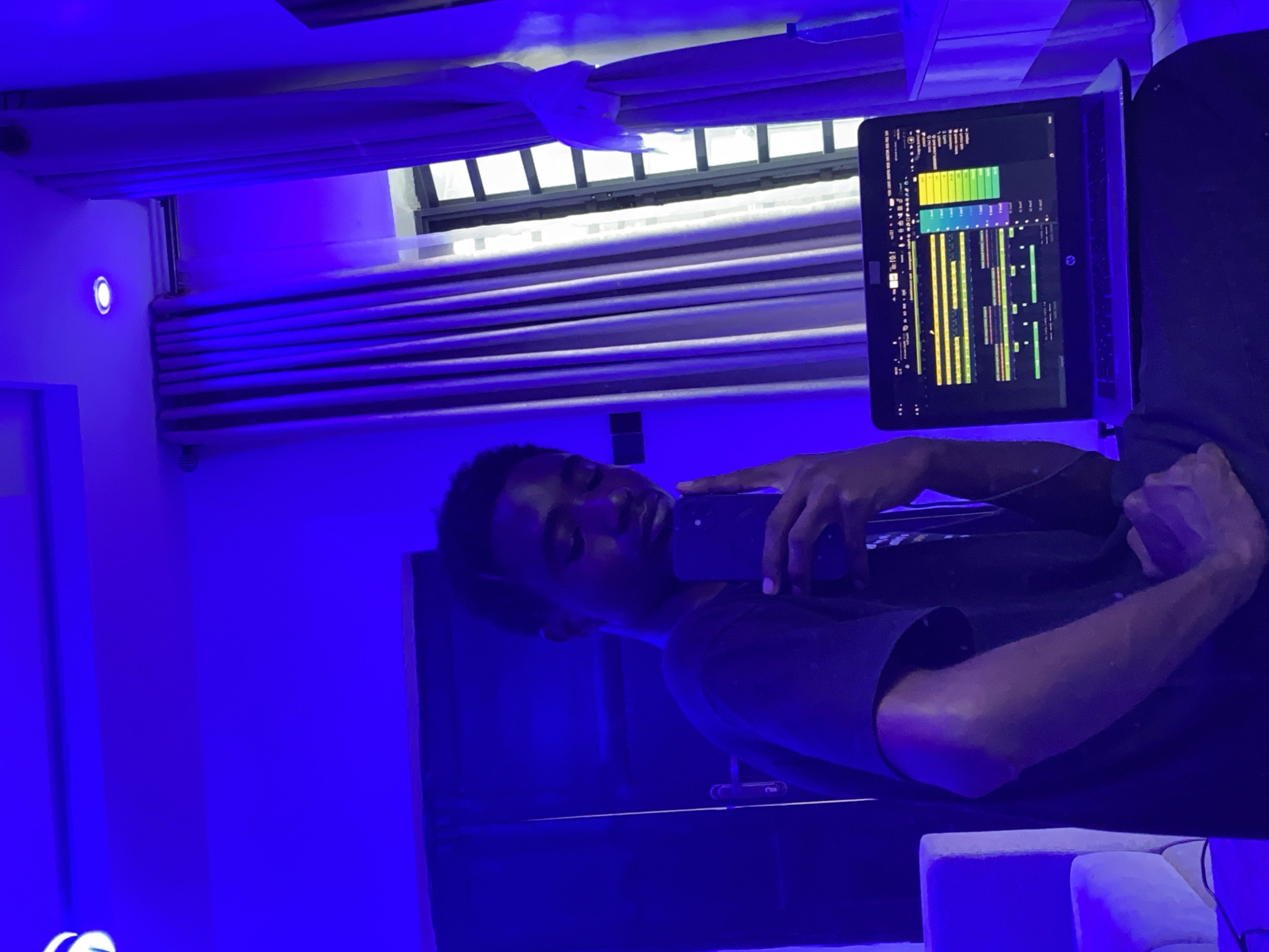 Music producer documented creating tracks in blue-lit Ibadan studio