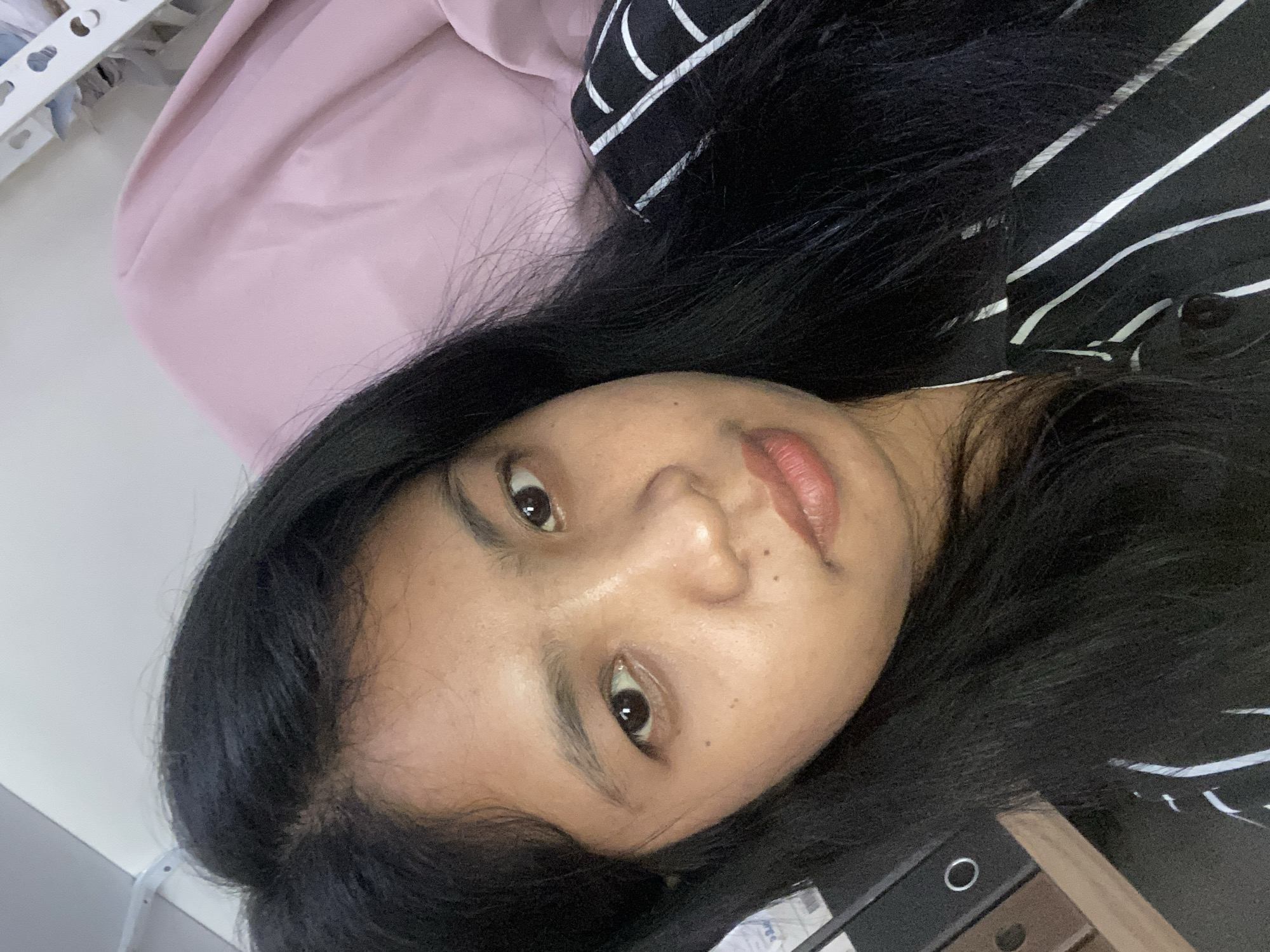 Woman photographed repeatedly indoors in Negara, Indonesia early morning