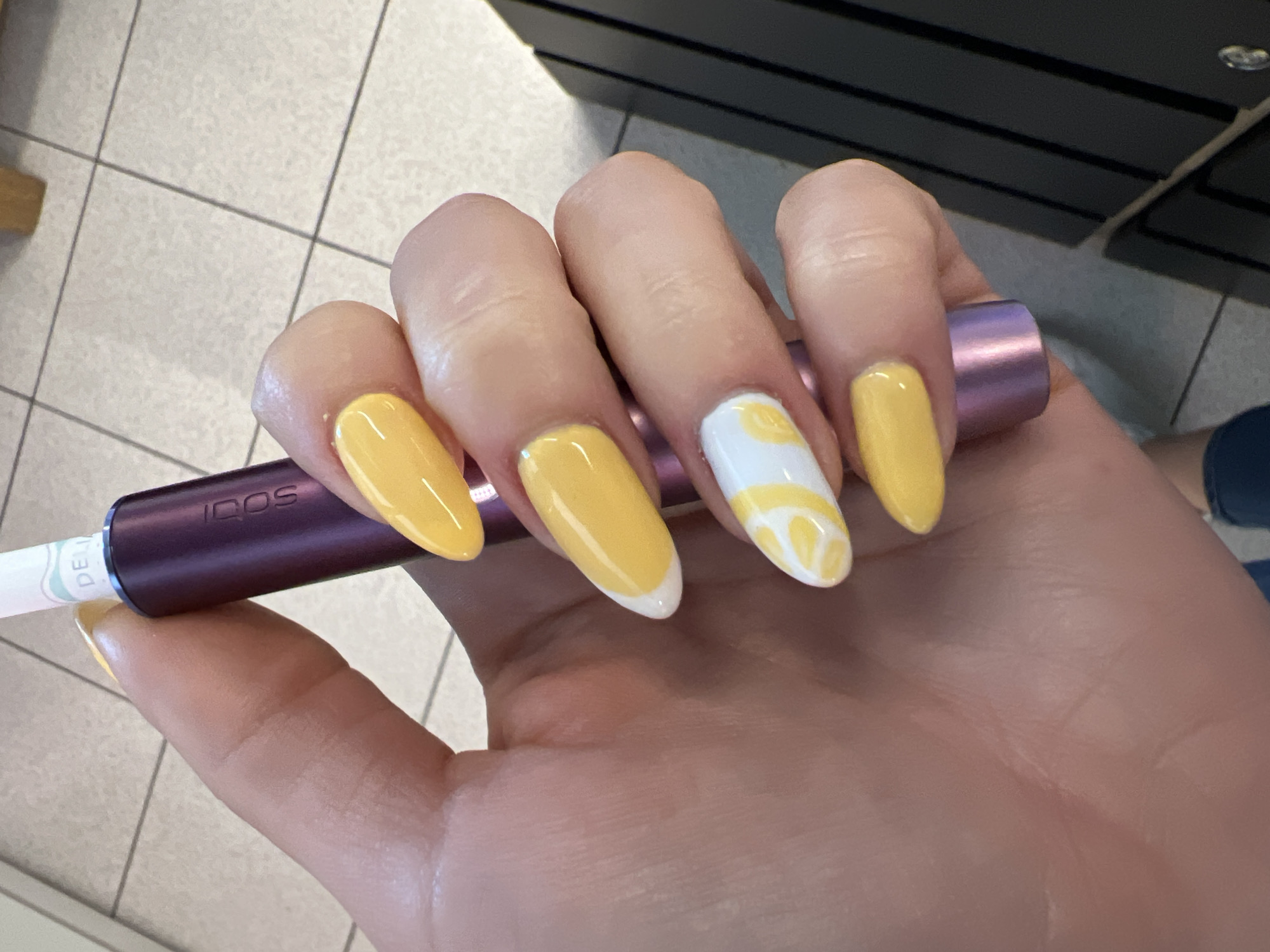 Yellow nails and a metallic purple IQOS in Pazardzhik