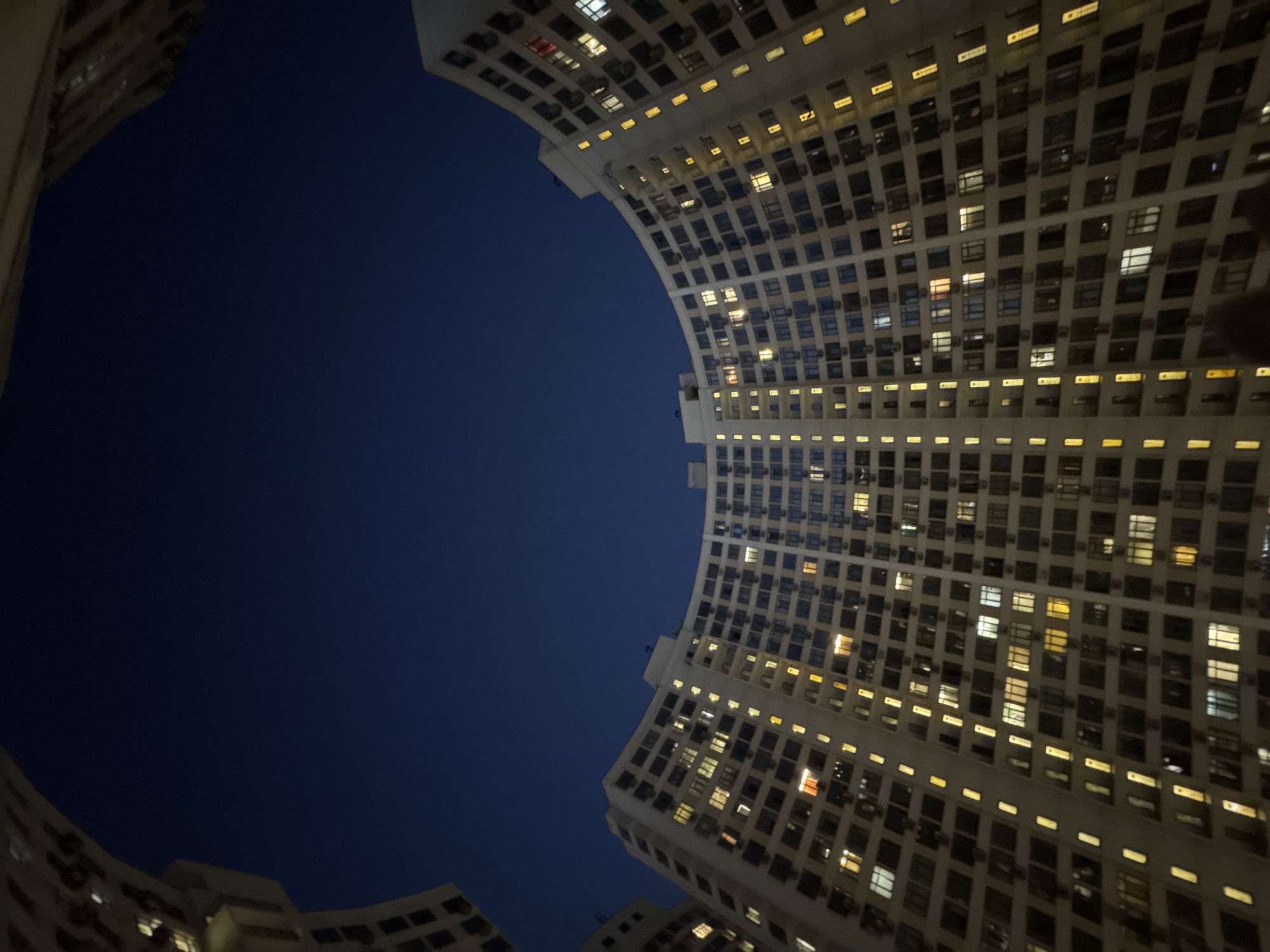 Odesa residential complex glows at night, courtyard fountain visible