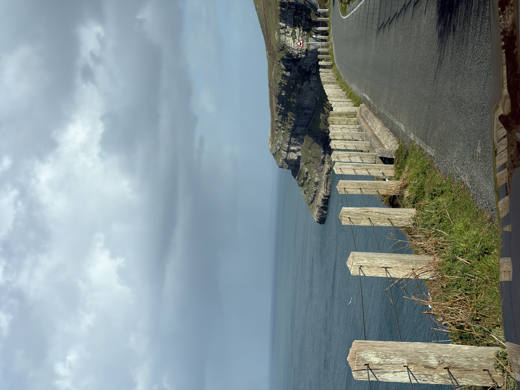 Coastal road with wooden fence observed in Llandudno
