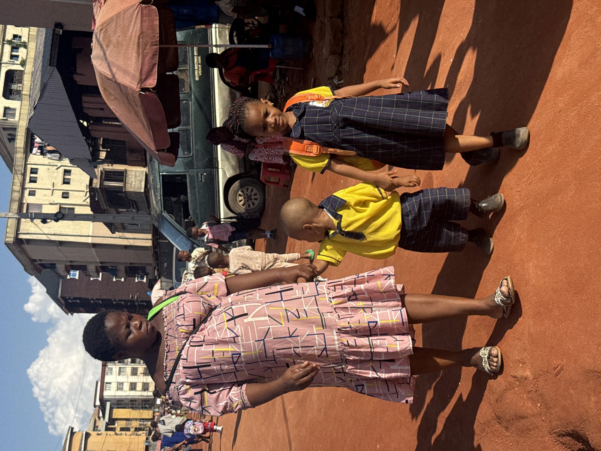 Schoolkids fill the streets of Onitsha on a bright afternoon