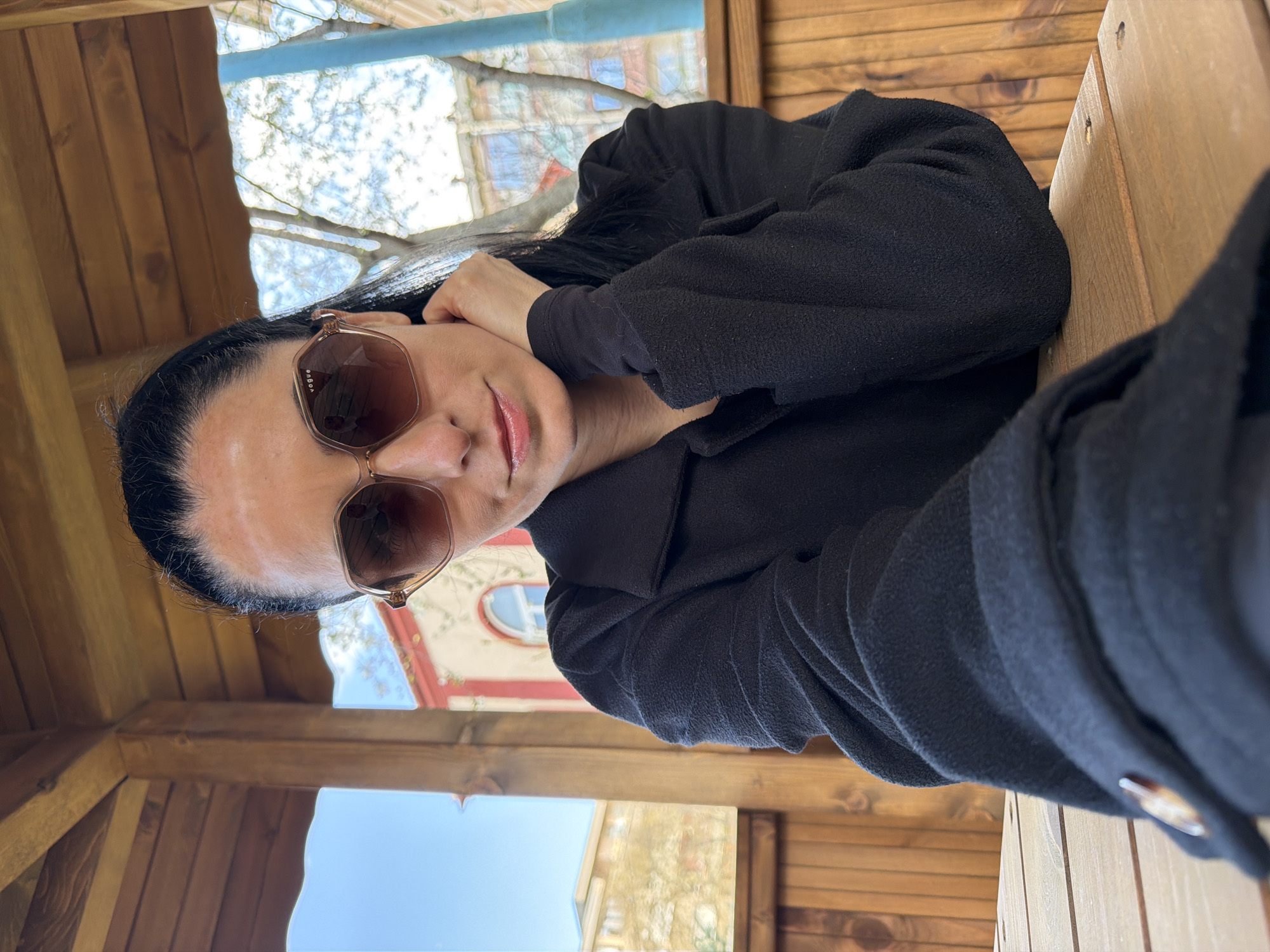 Woman in sunglasses rests at park structures in Pleven
