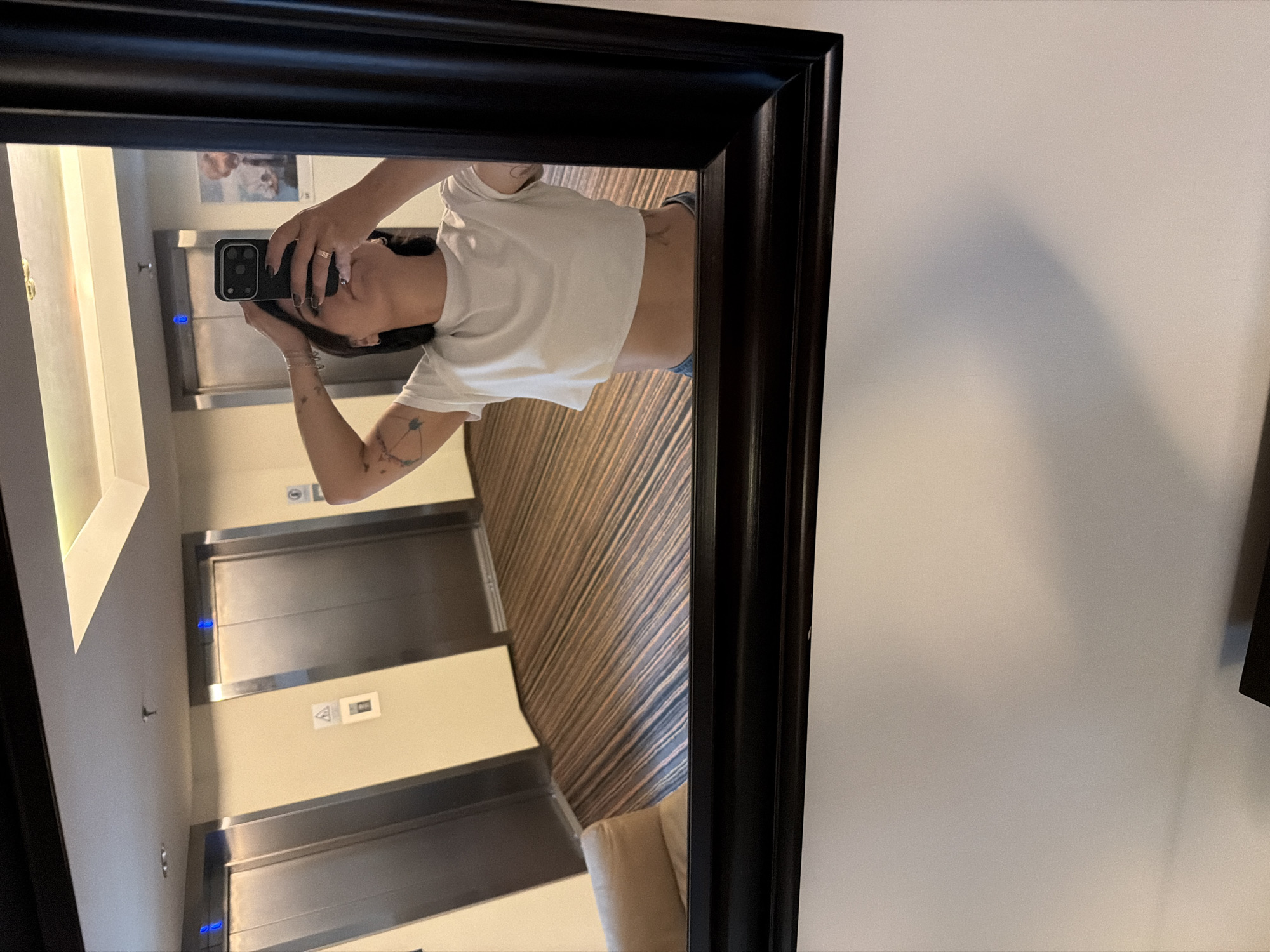 Mirror selfie in a Khimki hotel hallway near elevator bank