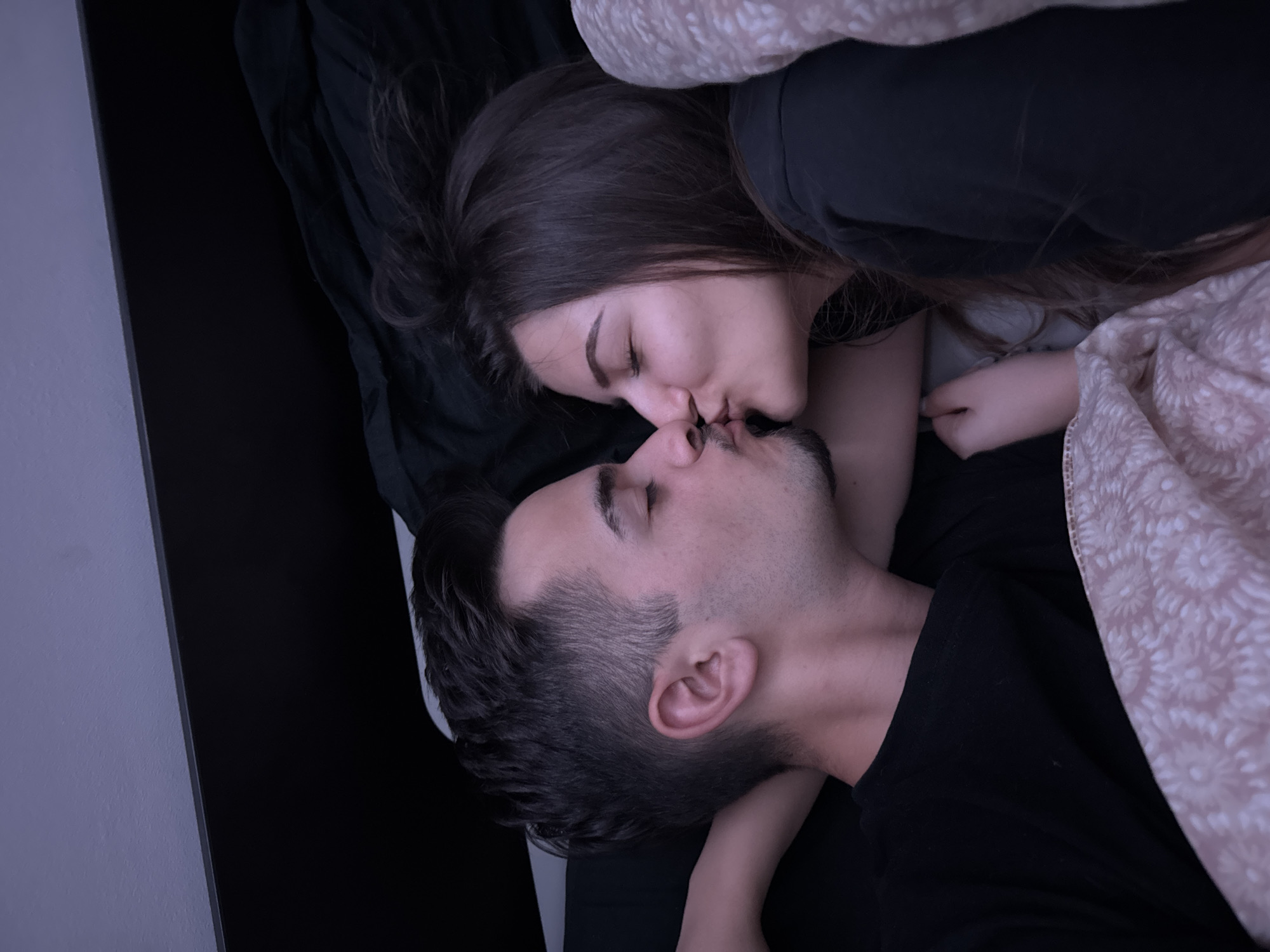 Intimate moment captured between couple in Sofia bedroom