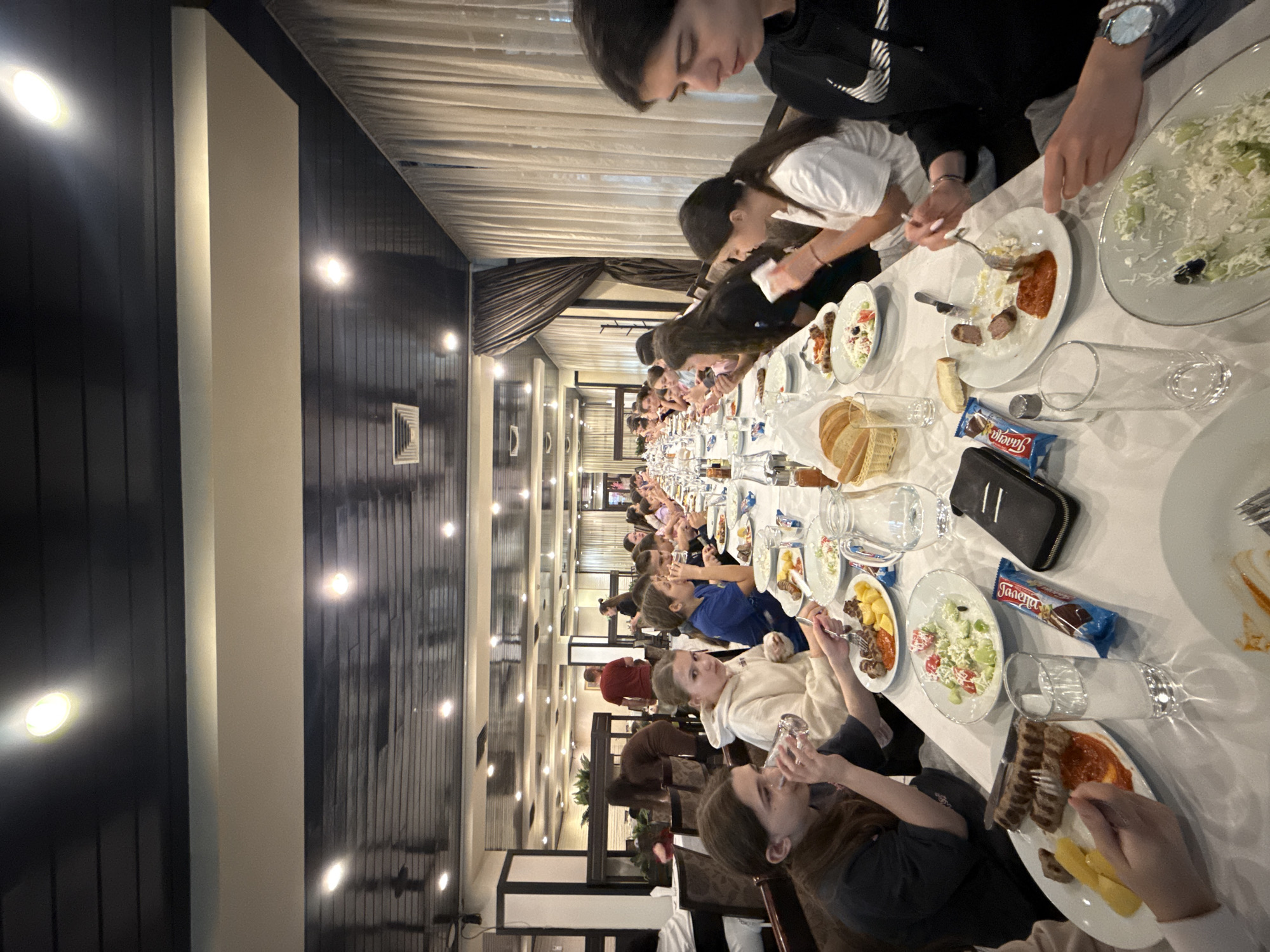 Large group shares meal at restaurant in Etropole, Bulgaria