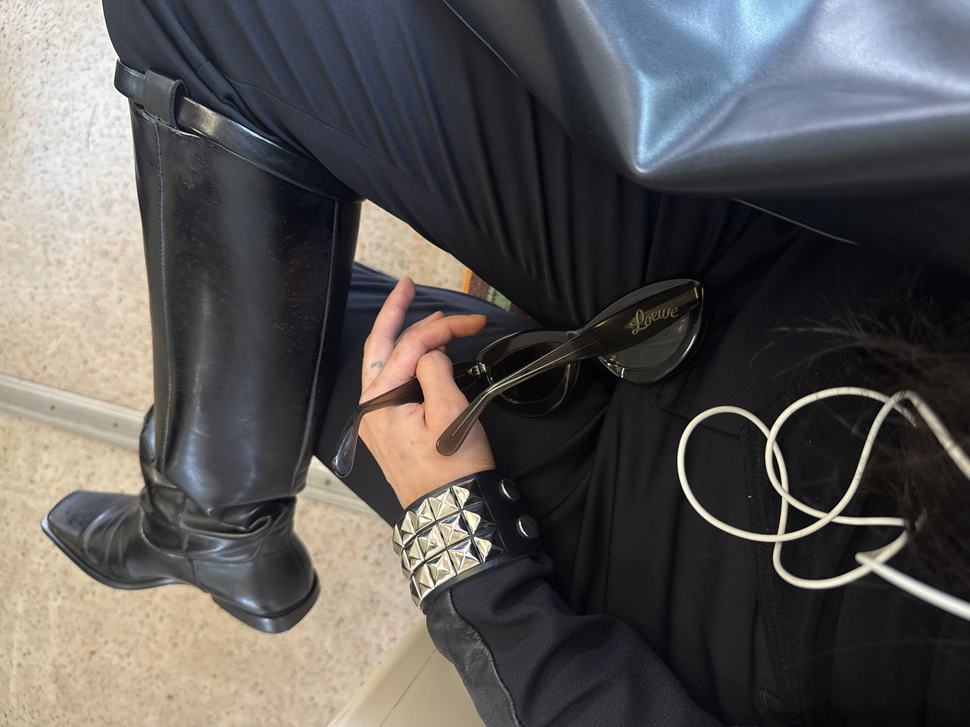 Person in black attire observed seated in London