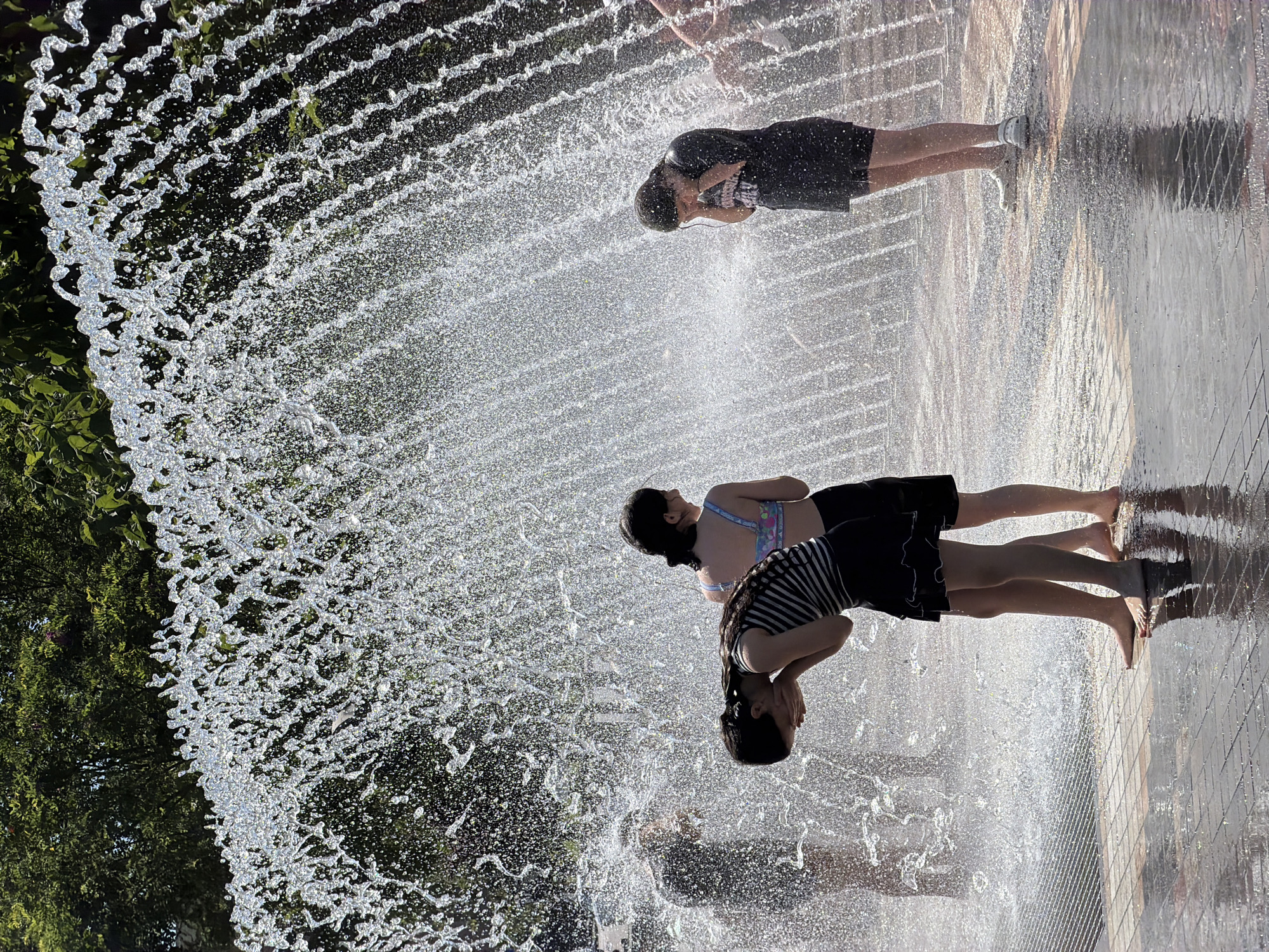 Kids cool off at a Yerevan splash pad on a summer morning