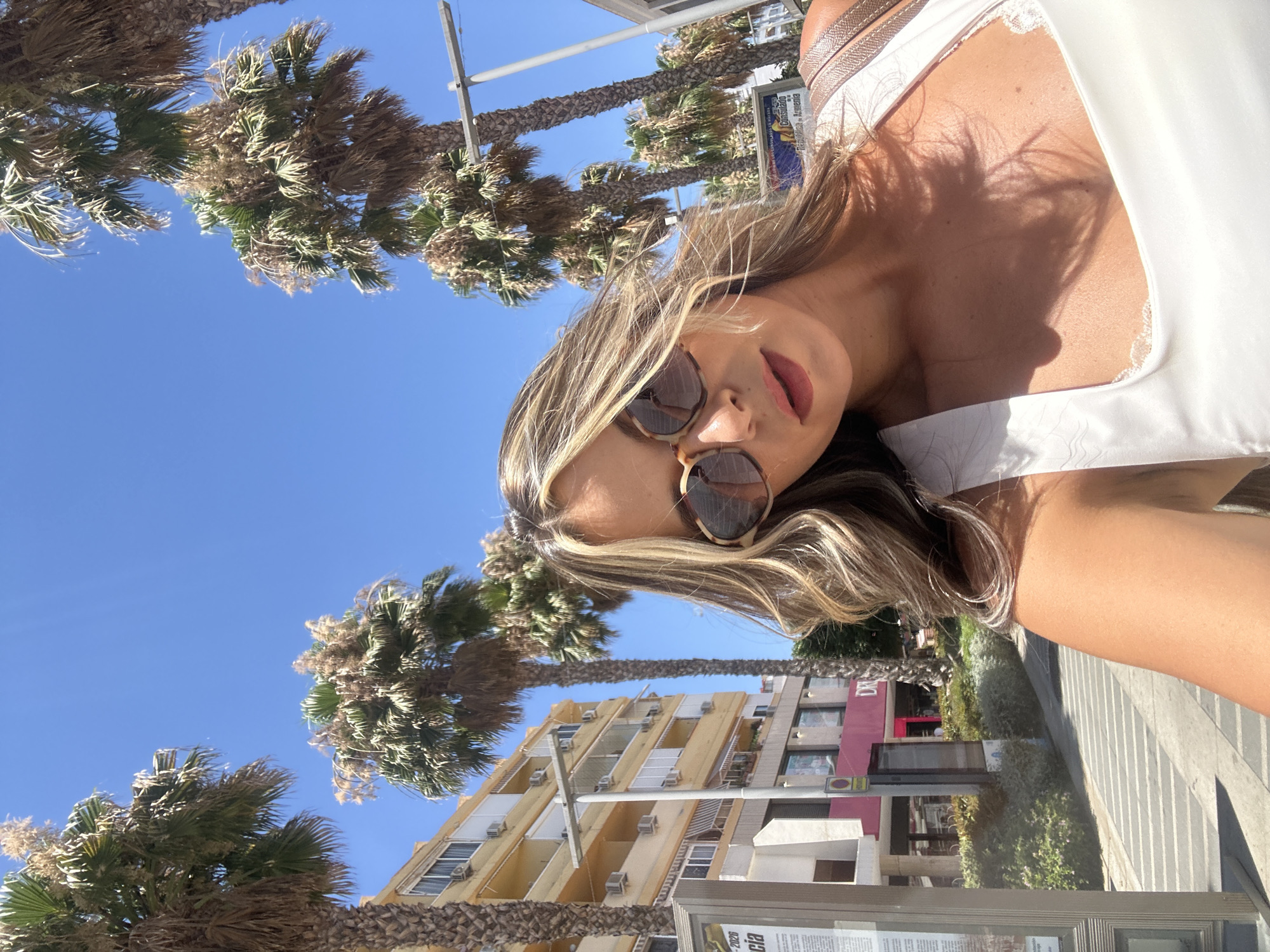 Sunny selfie among palm trees in Torremolinos, Spain