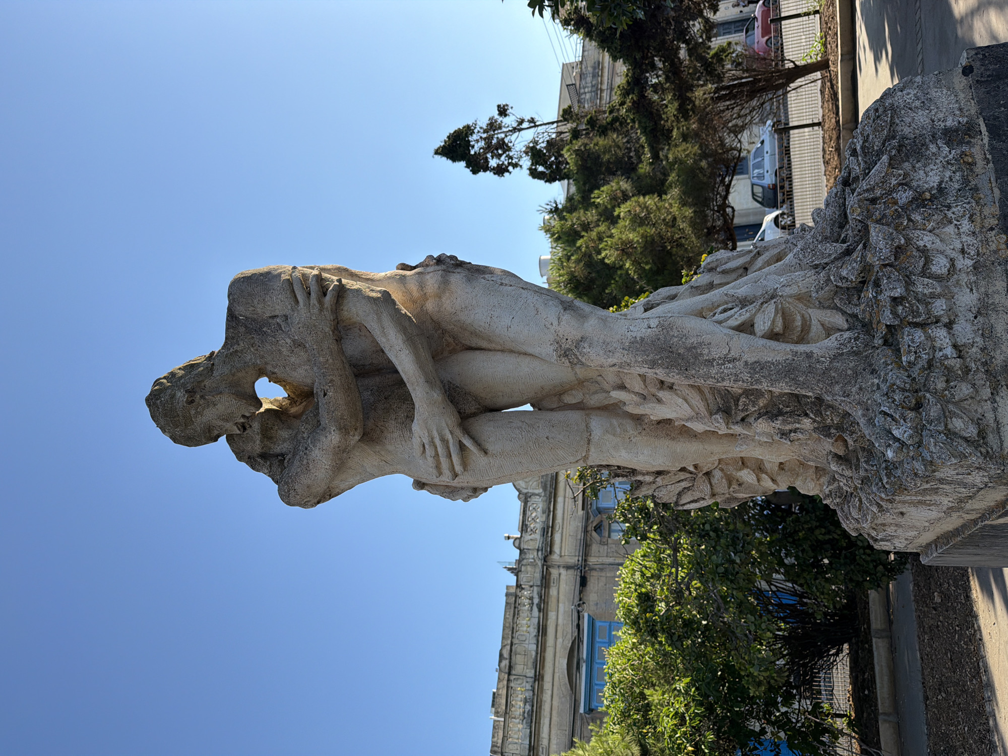 Expressive stone sculpture of two entwined figures in Rabat, Malta
