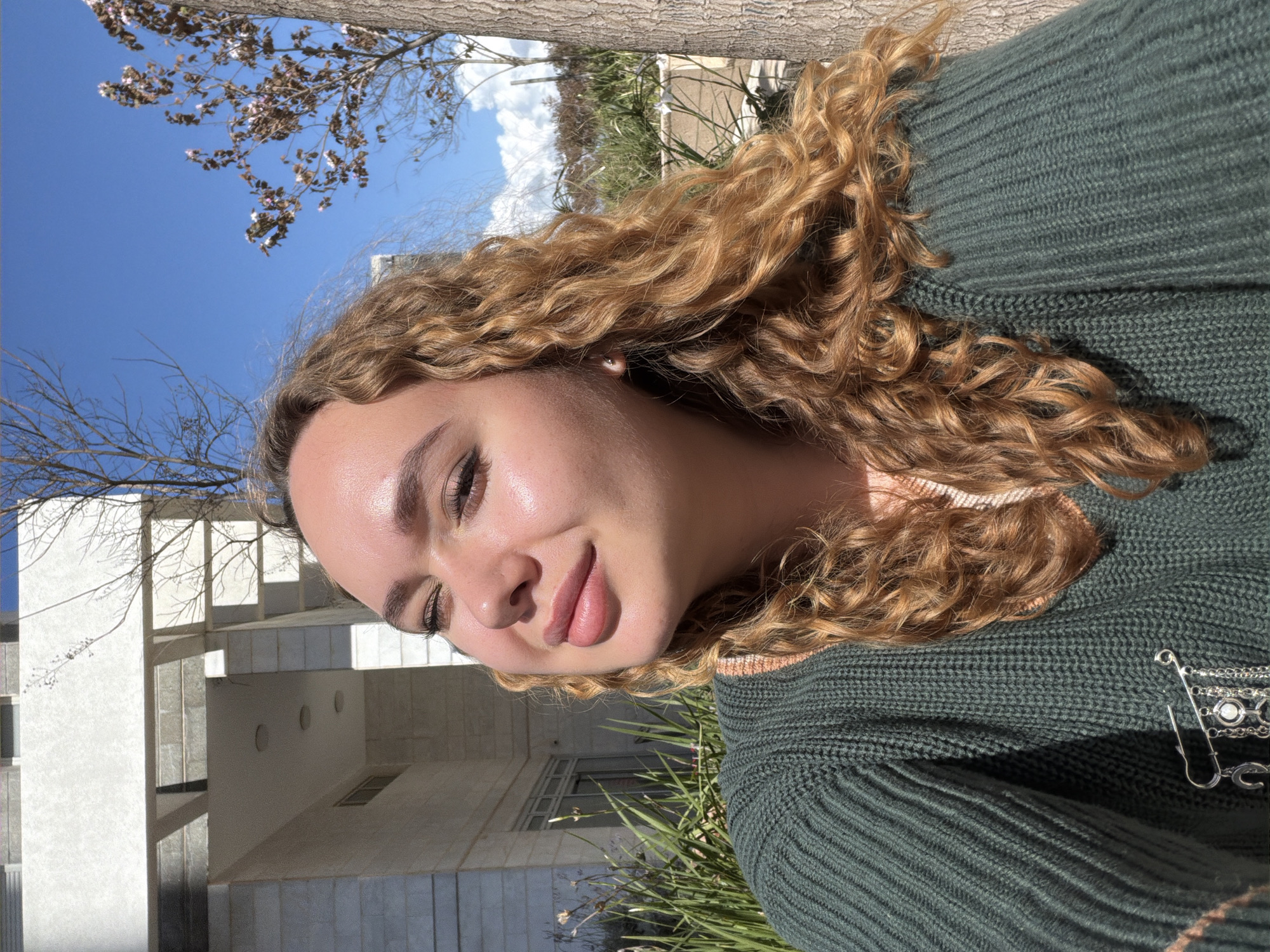 Woman poses amid modern architecture in Netanya street scene