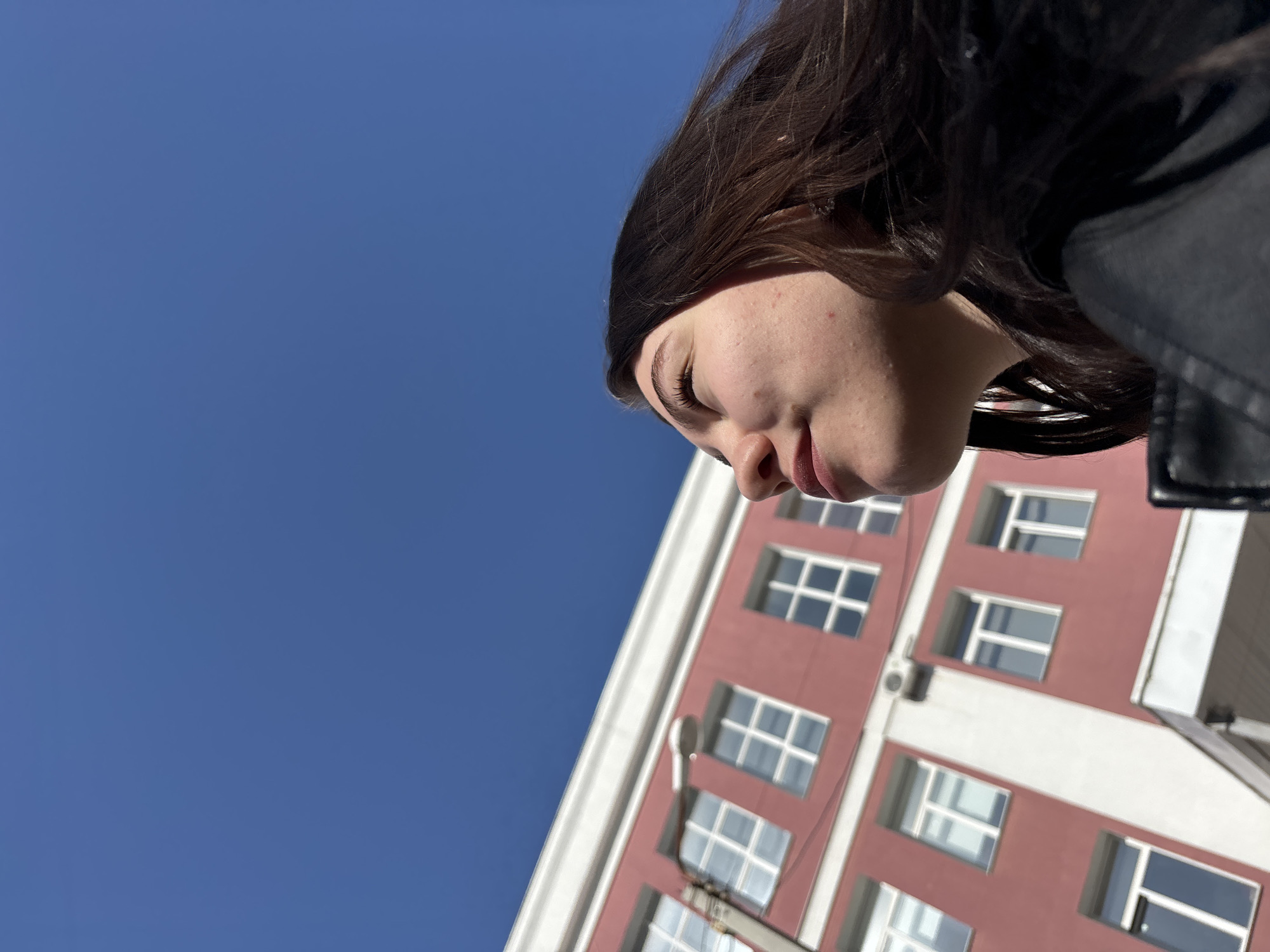 Woman photographed against building backdrop in Perm, Russia