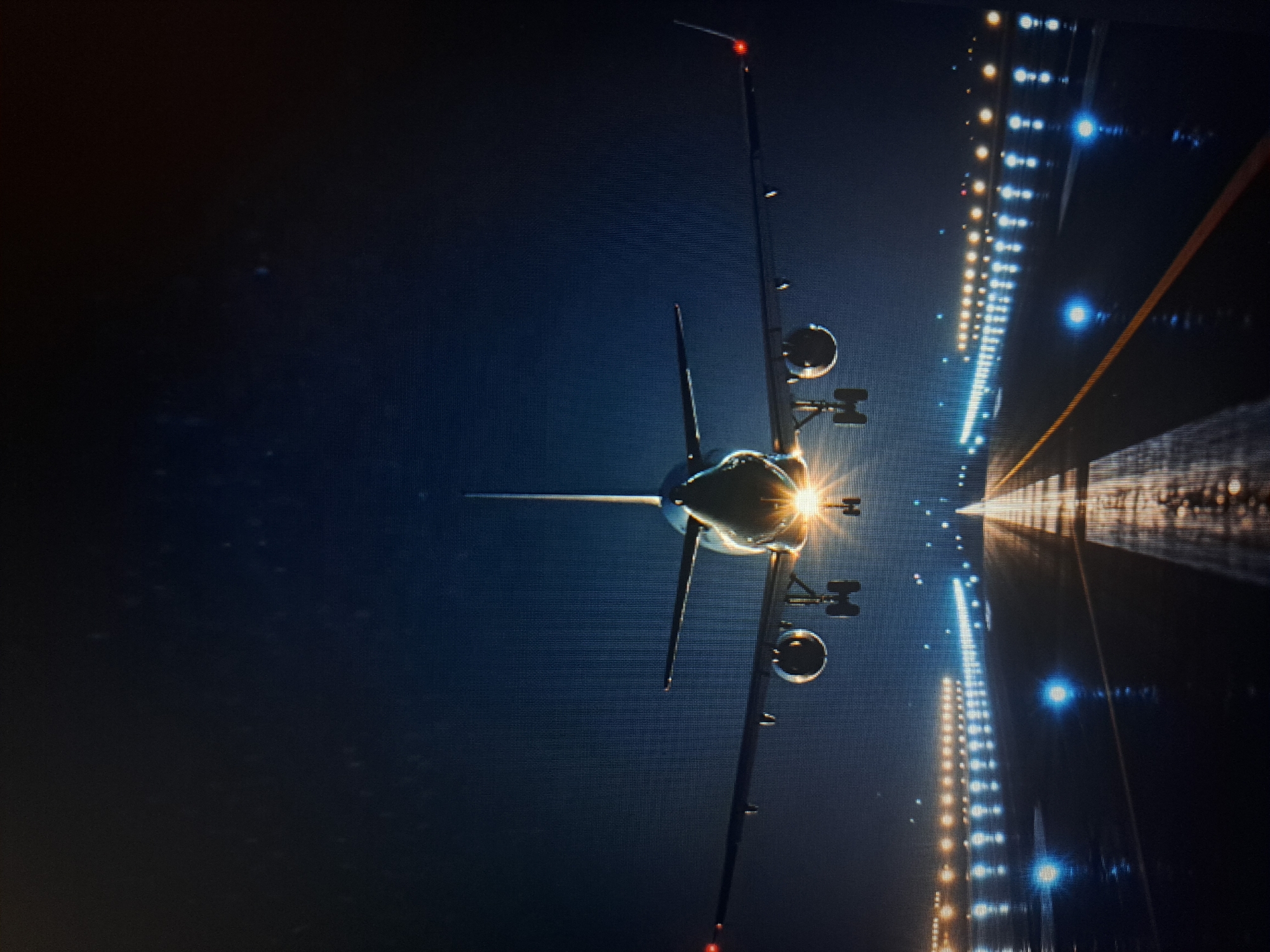 Aircraft positioned on illuminated runway in Yerevan at night