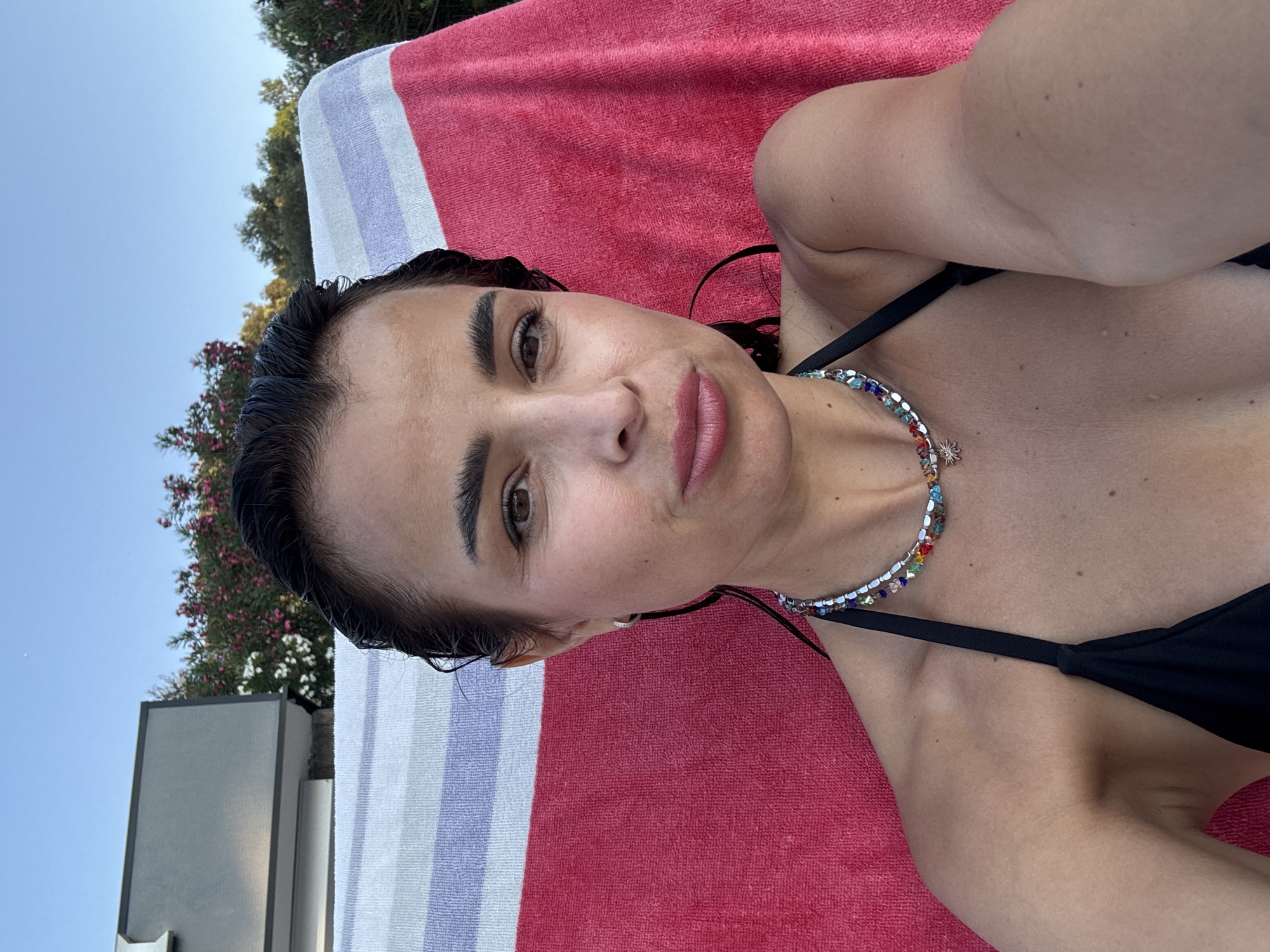 Afternoon selfies at a relaxed outdoor spot with a beaded necklace