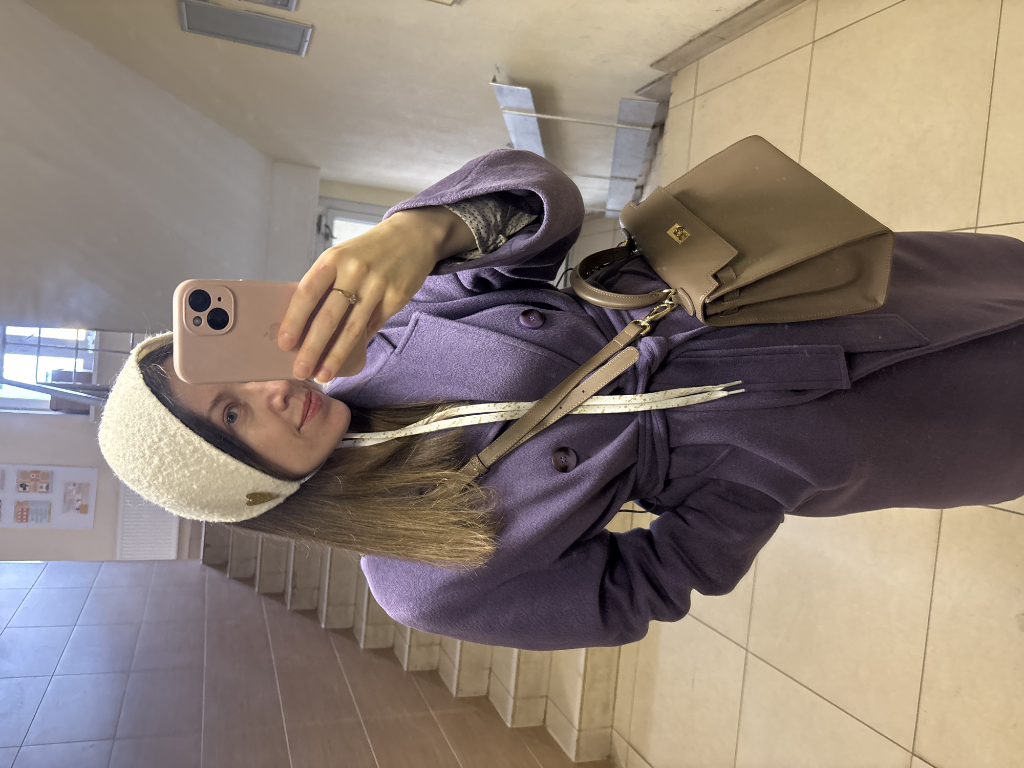 Woman takes selfie in Kudrovo stairwell